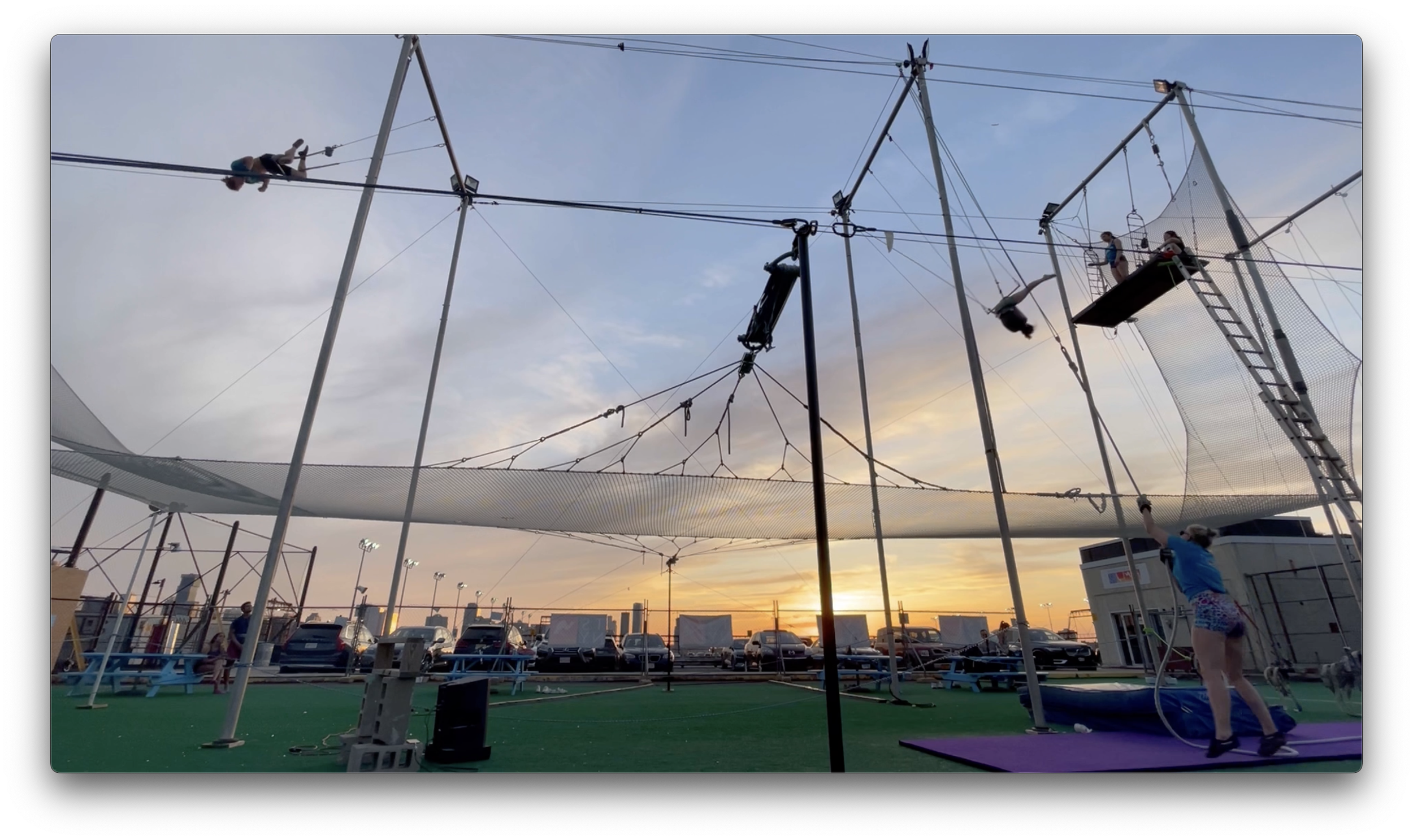 Savannah performing flying trapeze on a pier in NYC
