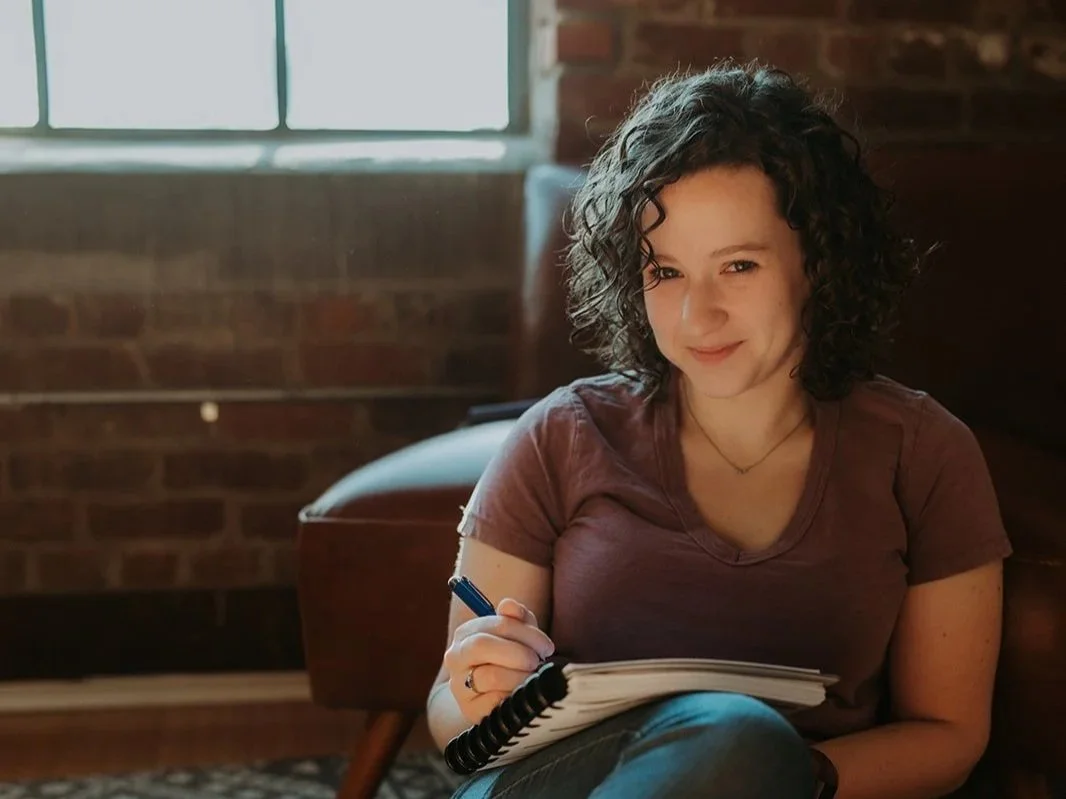 Photo of Savannah staring into the camera with pencil in hand.