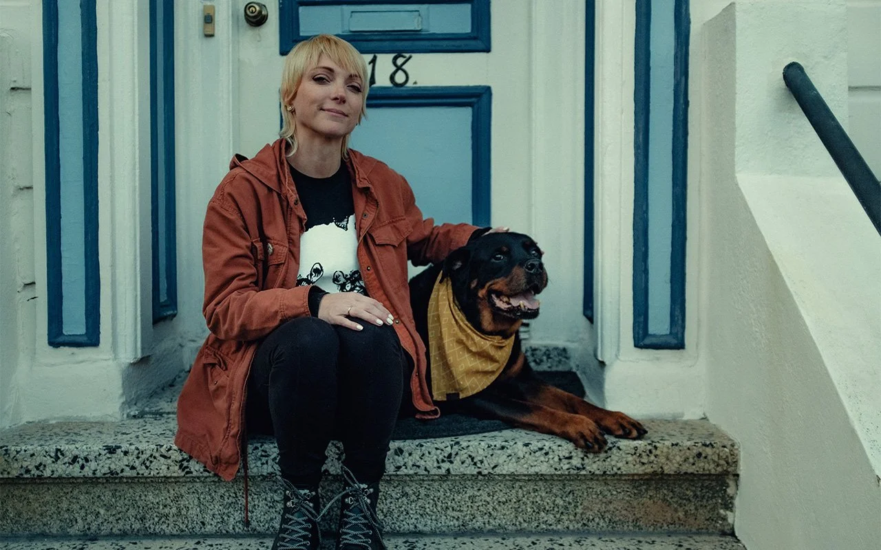 Kim sitting with dog on San Francisco steps