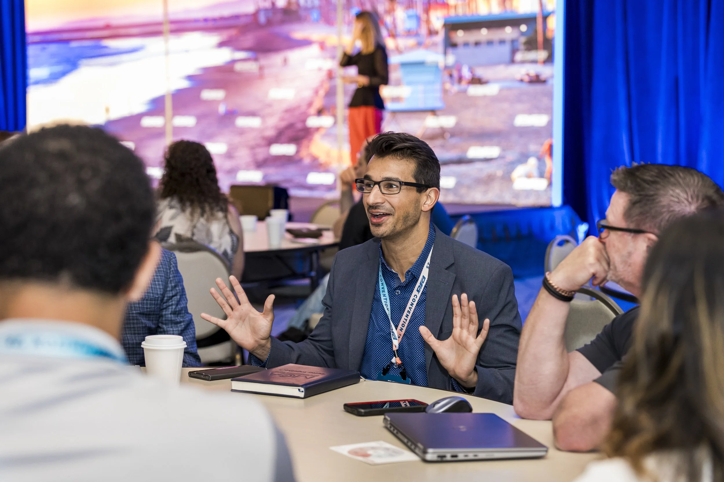 conference-attendee-speaking-during a roundtable-discussion.jpg