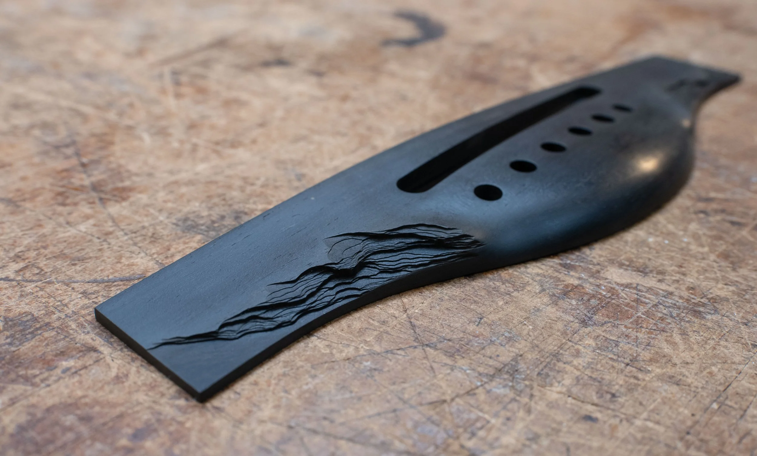 Guitar bridge with slate rock/bark texture. Ervin Somogyi apprenticeship.