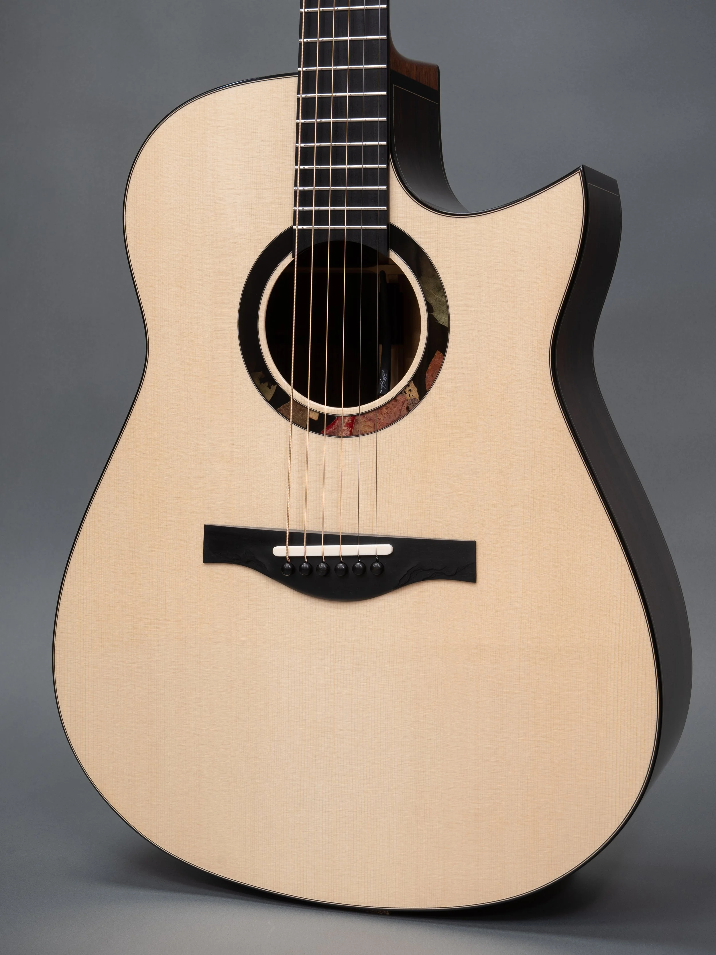 Silverman guitar, Swiss moon spruce top. Carved bridge.