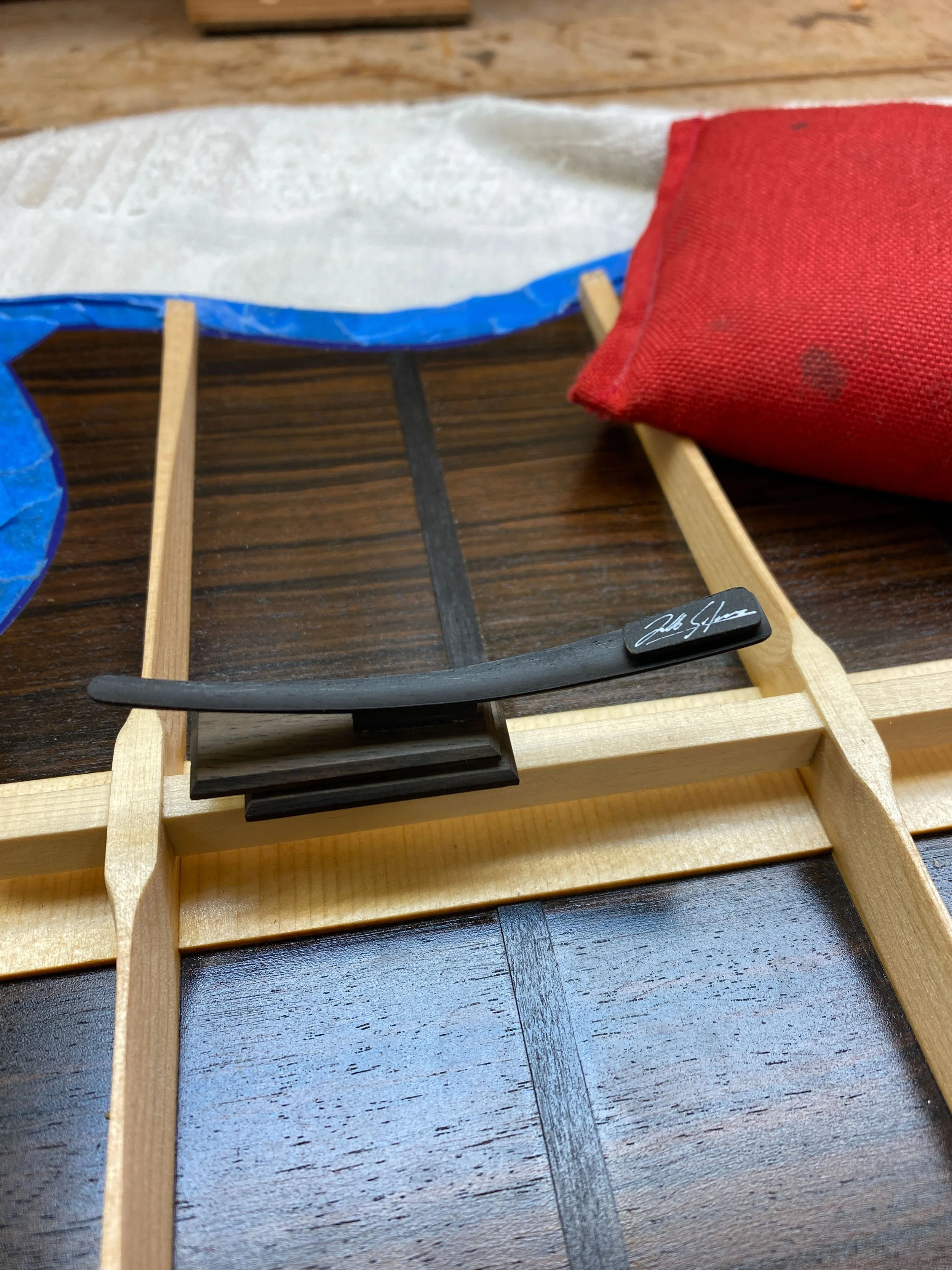 Silverman Guitars curved and carved label on floating back brace.