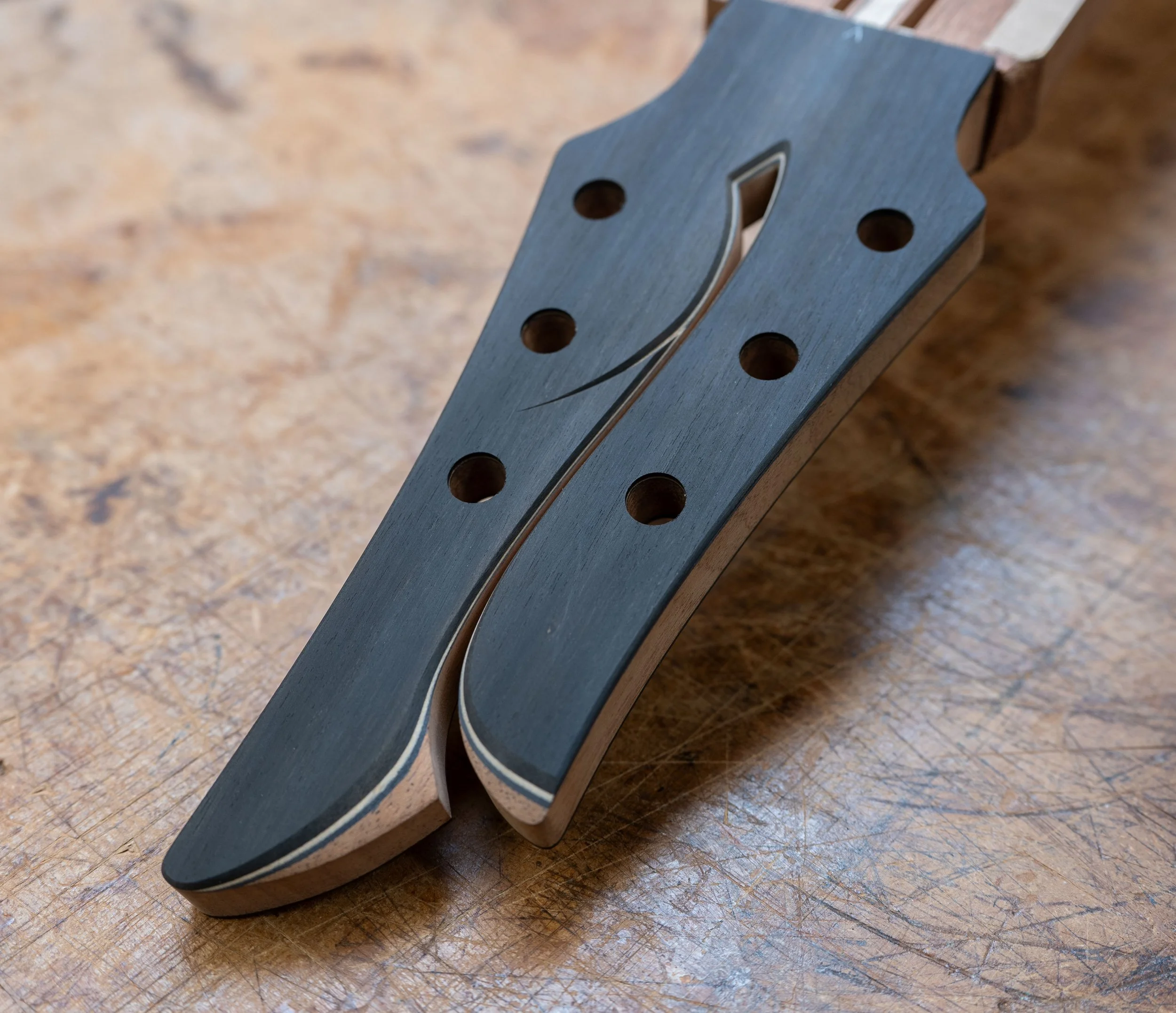 Silverman headstock, cut and bevelled in the middle