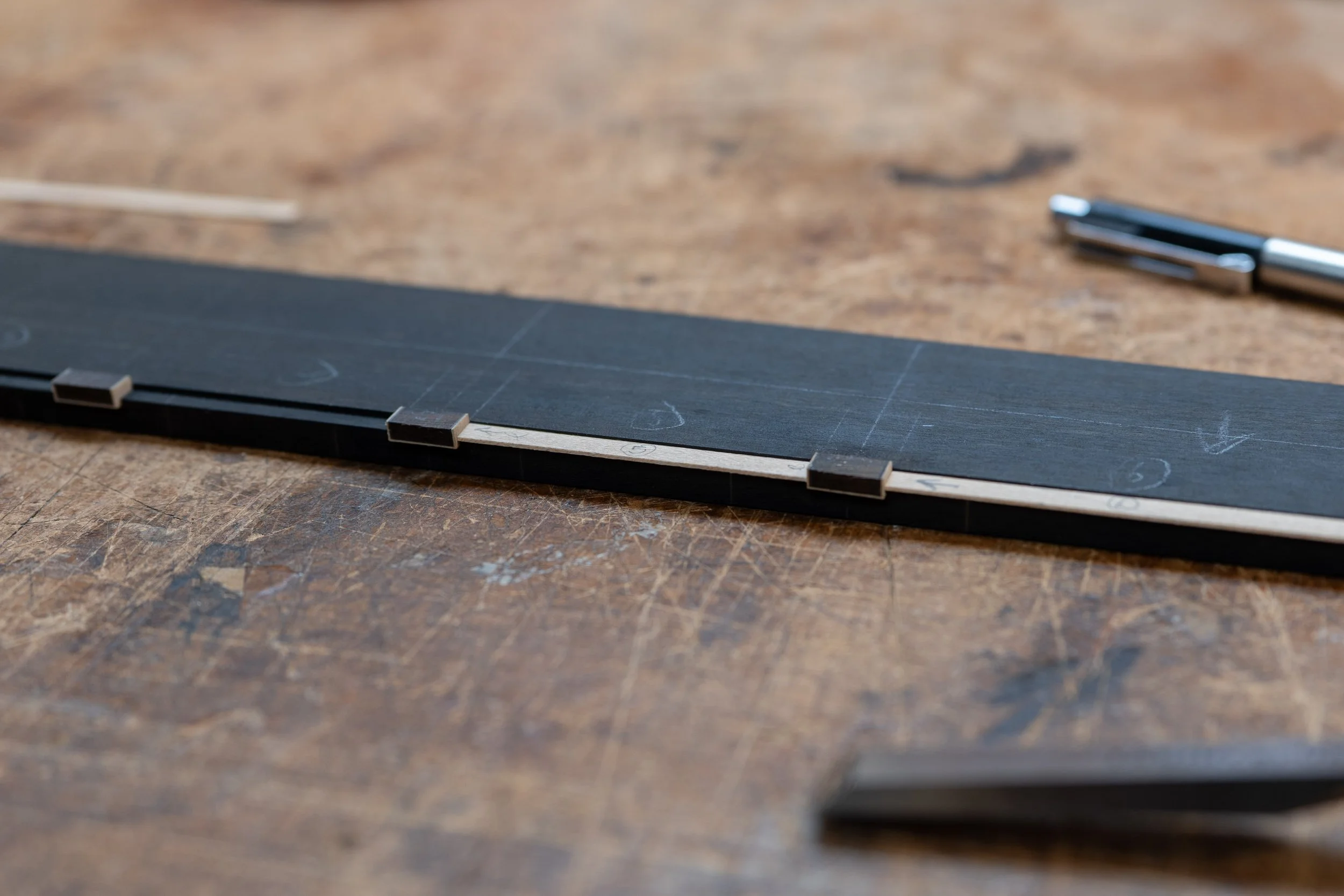 I then fit and glued white purfling in between. 