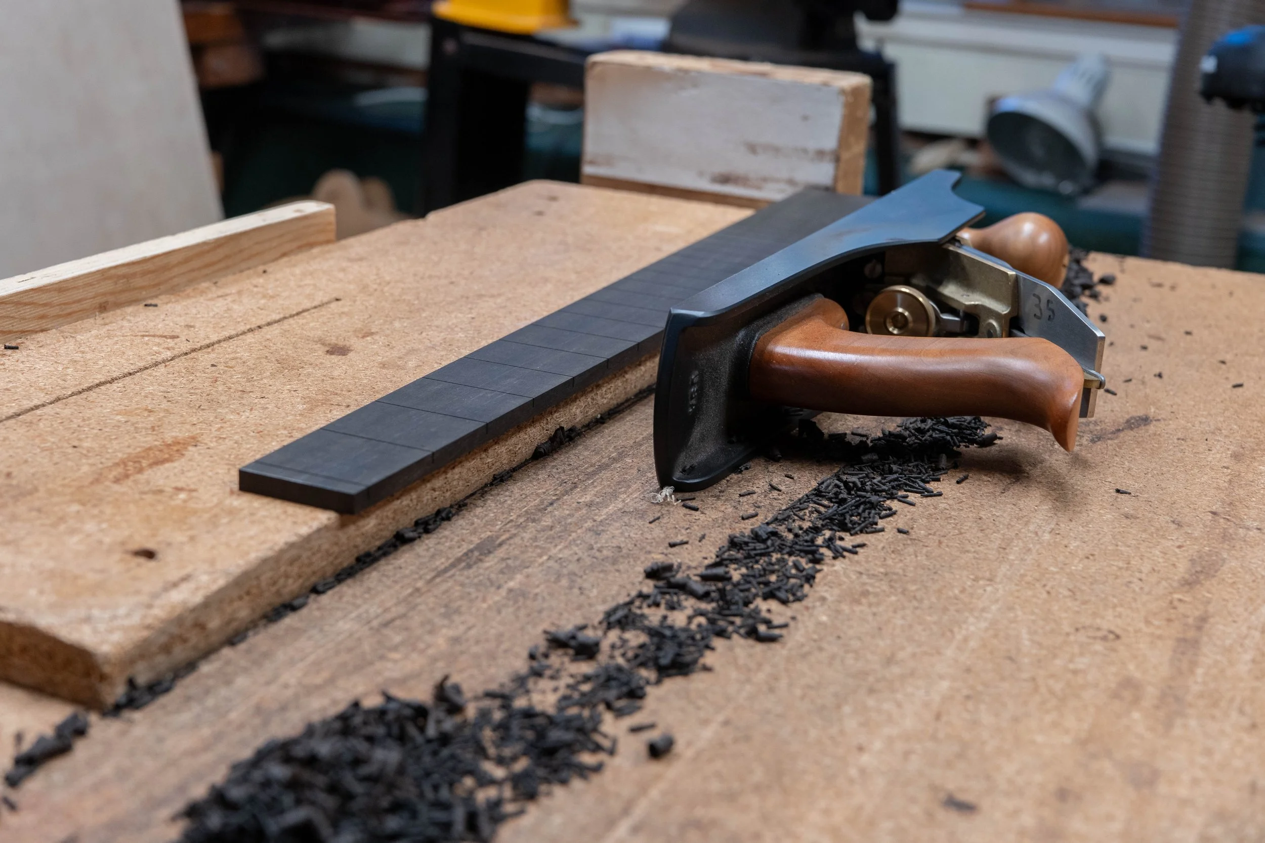 Trimming the fretboard width. 