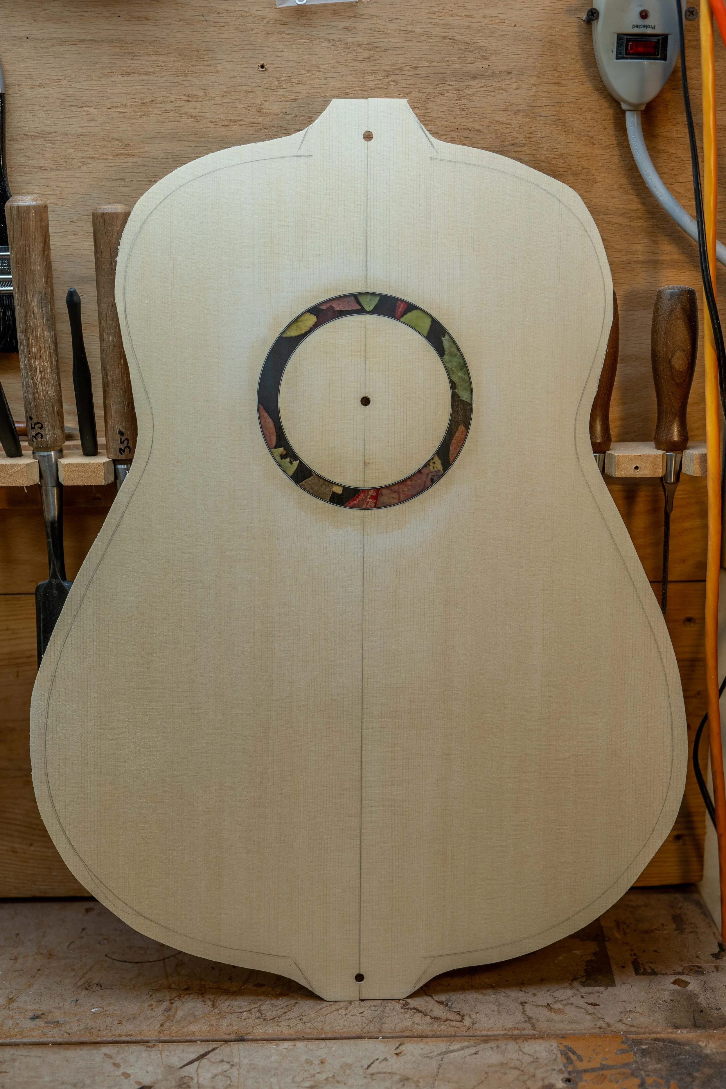 Then I sanded the rosette flush with the top. The sanding scratches reduce the clarity of the rosette somewhat, but the clarity will come back with finish. 