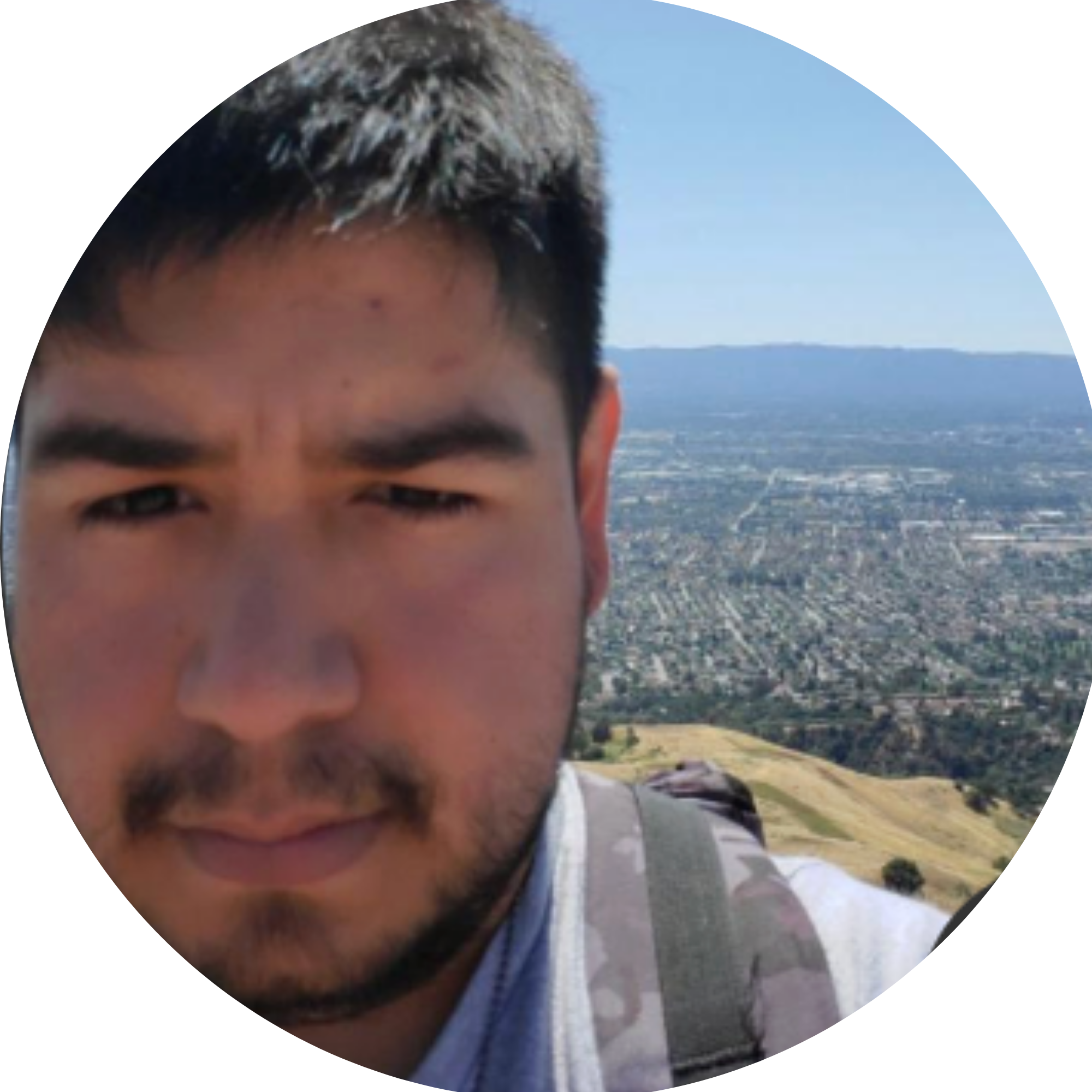 A woman in a yellow life jacket taking a selfie while kayaking on a river during sunset, with a person in a kayak in the background.
