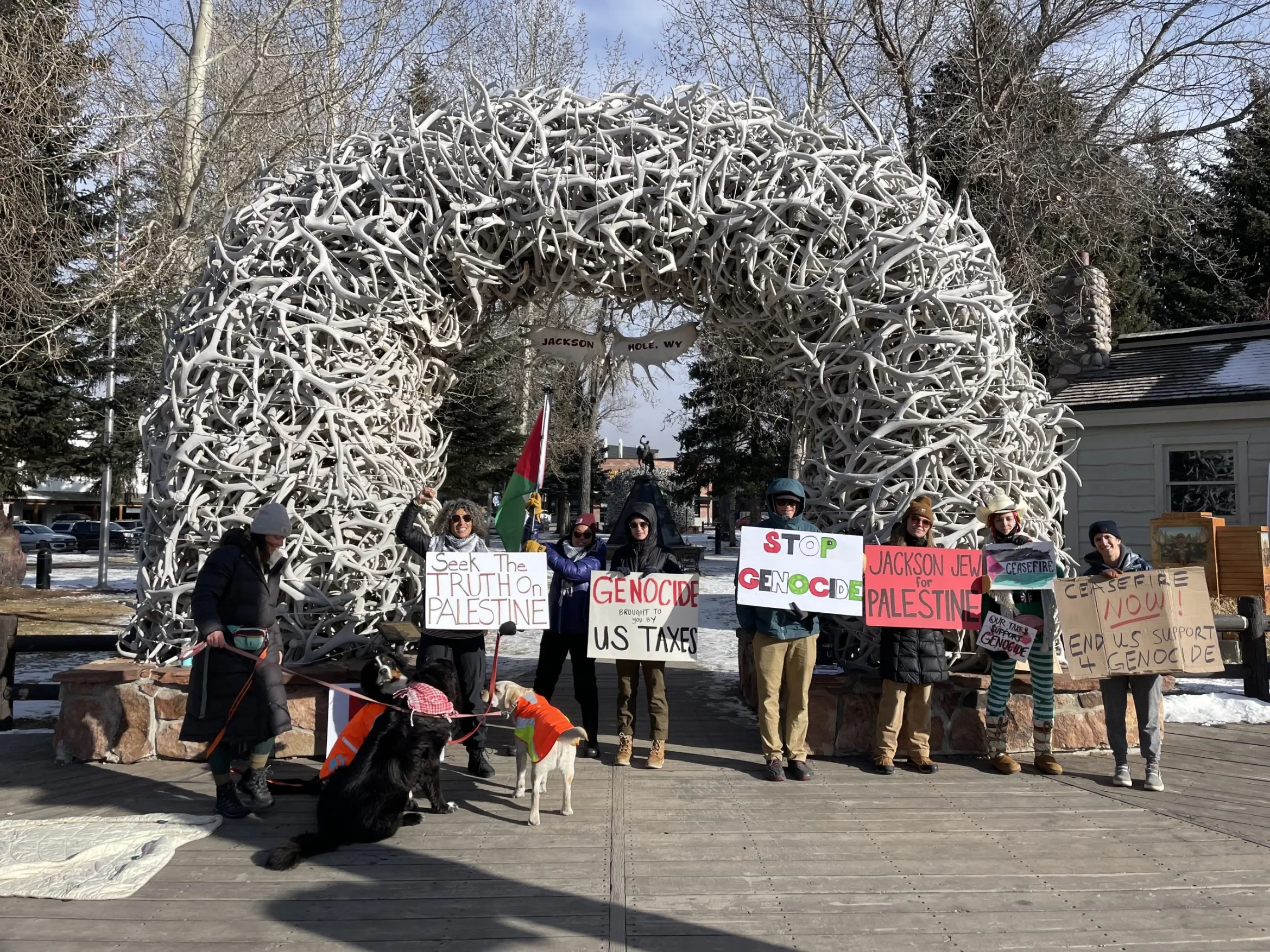 Jackson Hole for Free Palestine protestors holding signs and flags at the Town Square in Jackson, WY.