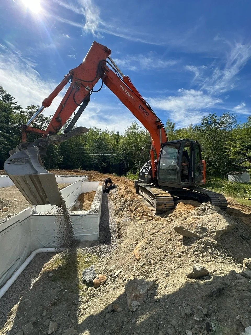 escavator installing an ICF foundation in Maine