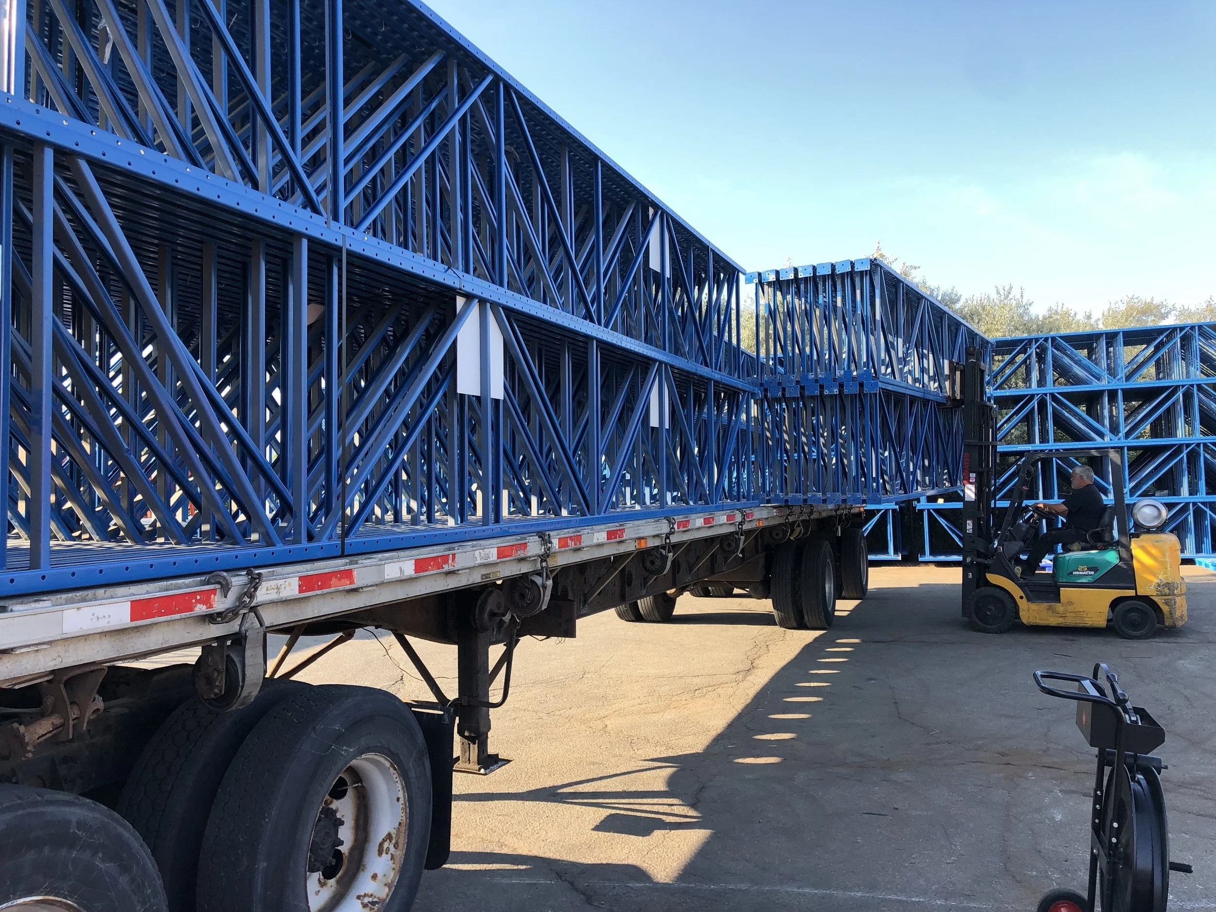 unloading trailer load of used RediRack pallet racking frames