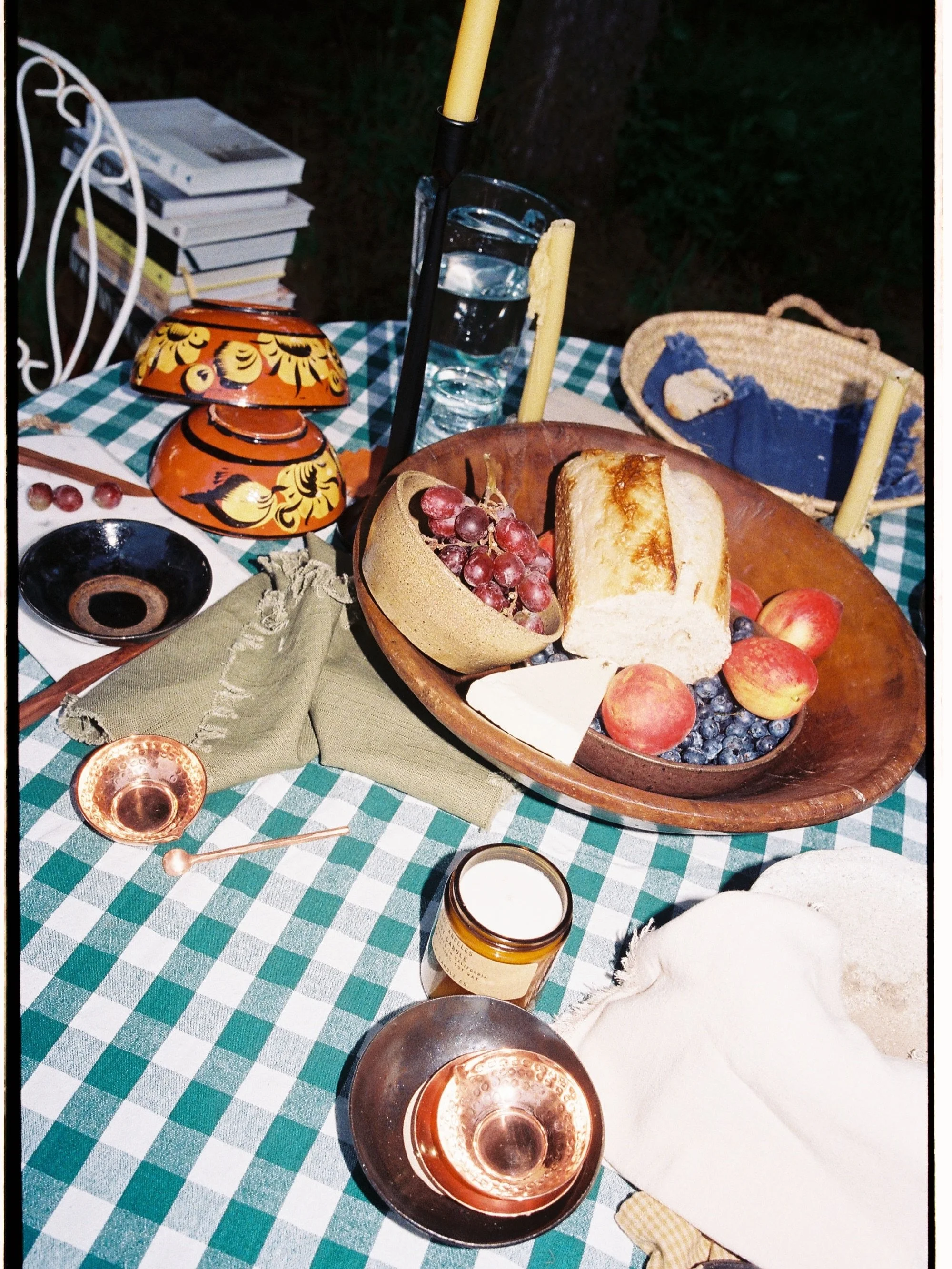 Somewhere in the Missouri backwoods, there&rsquo;s a table setting like this waiting for you 🍒🧀🥖🧺 many of our favorite things layered into these images &mdash; pottery, baskets, Moroccan glassware, rugs, candles &mdash; all handmade and ready for