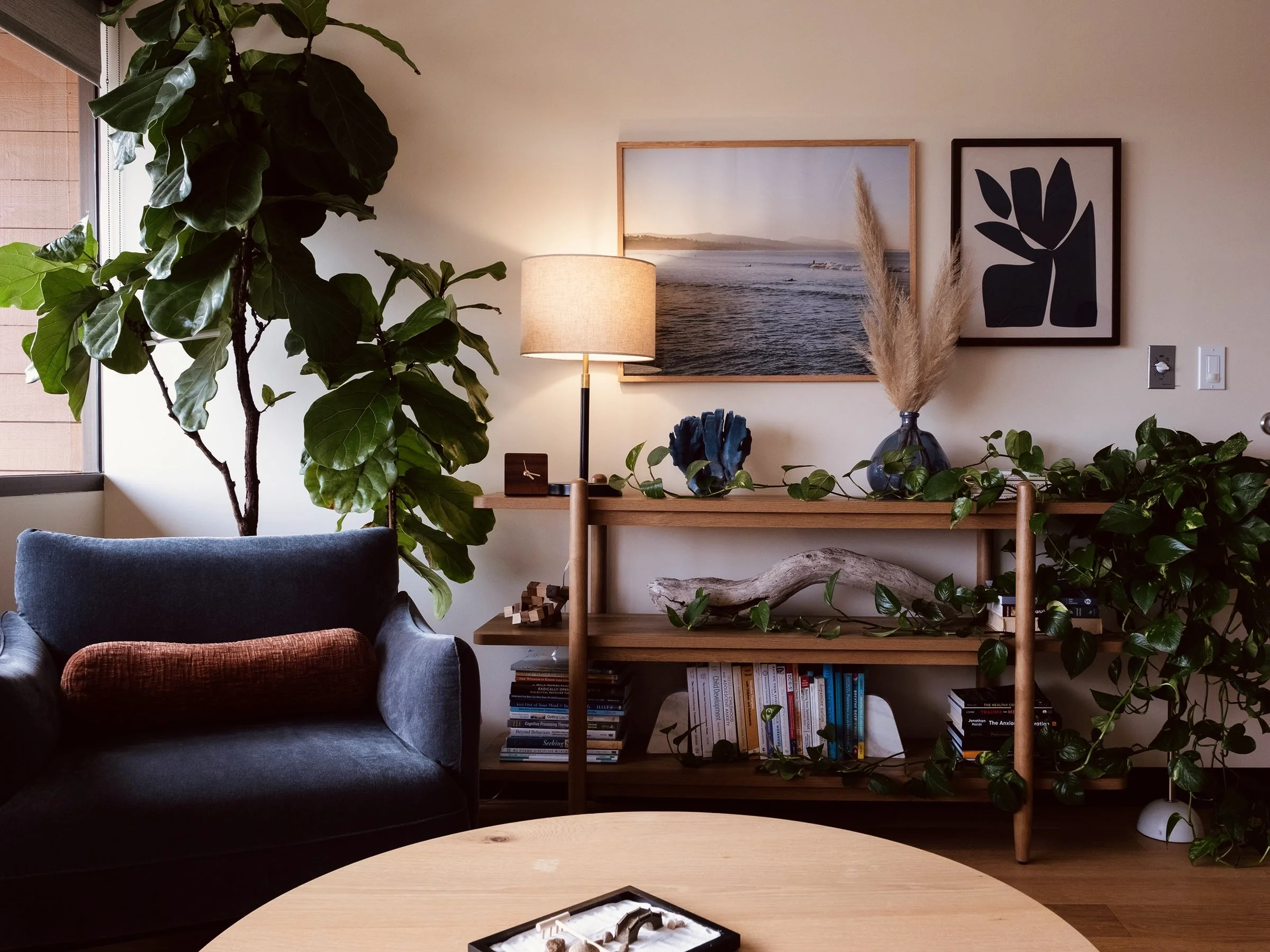 Ventura, CA therapy office with large plants, table lamp, and oversized blue chair.