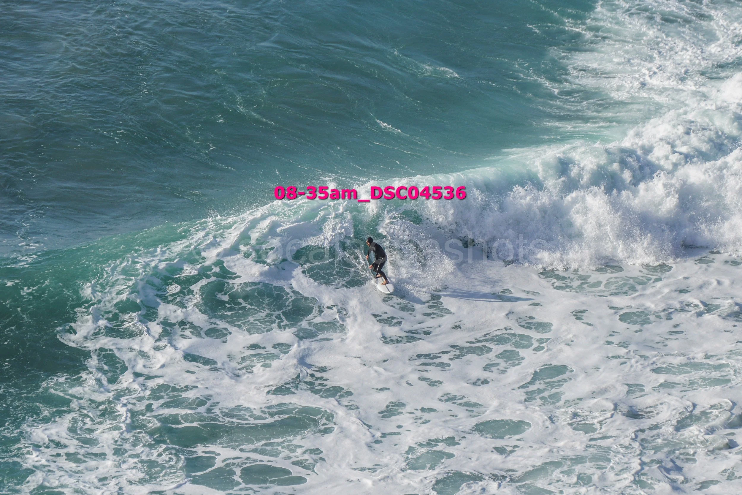 Surfer riding a wave in the ocean.
