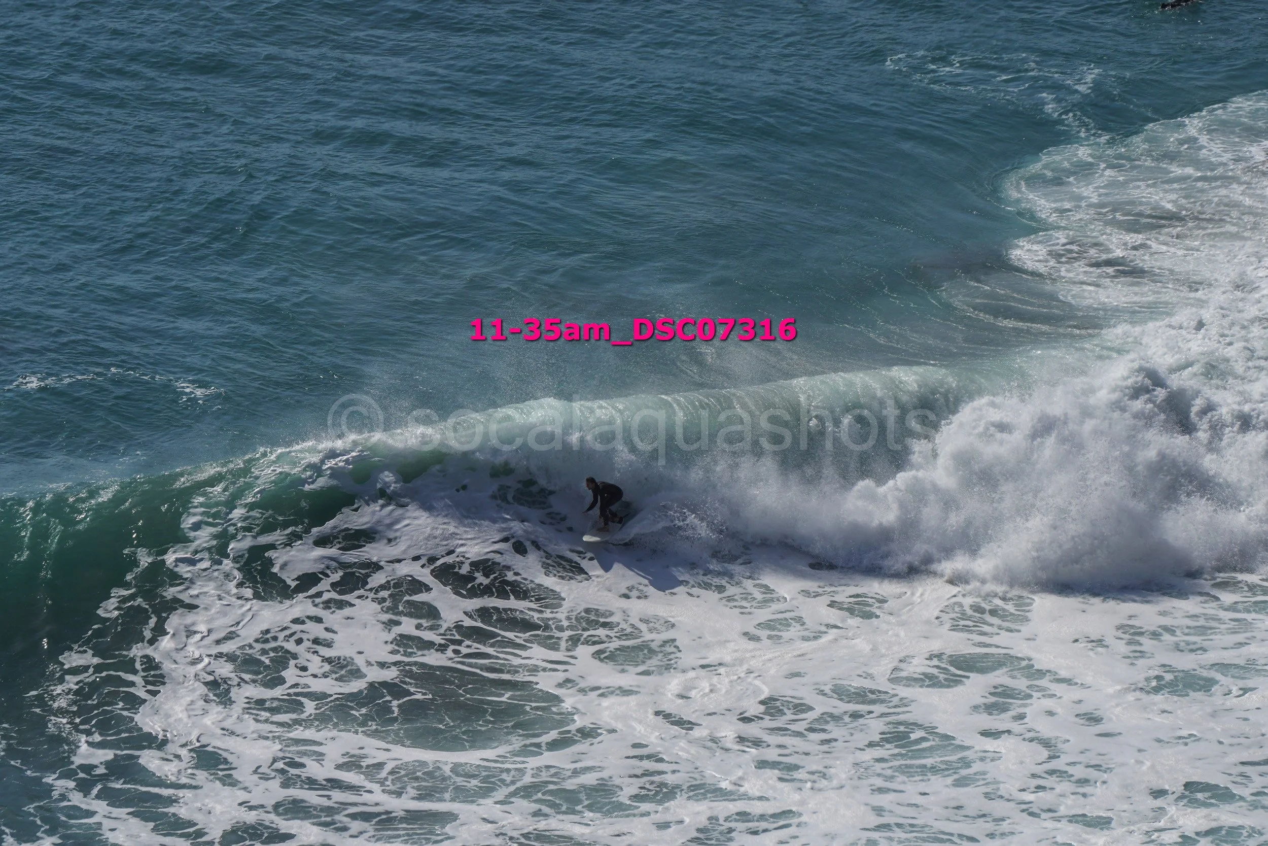 A person surfing on a wave in the ocean.