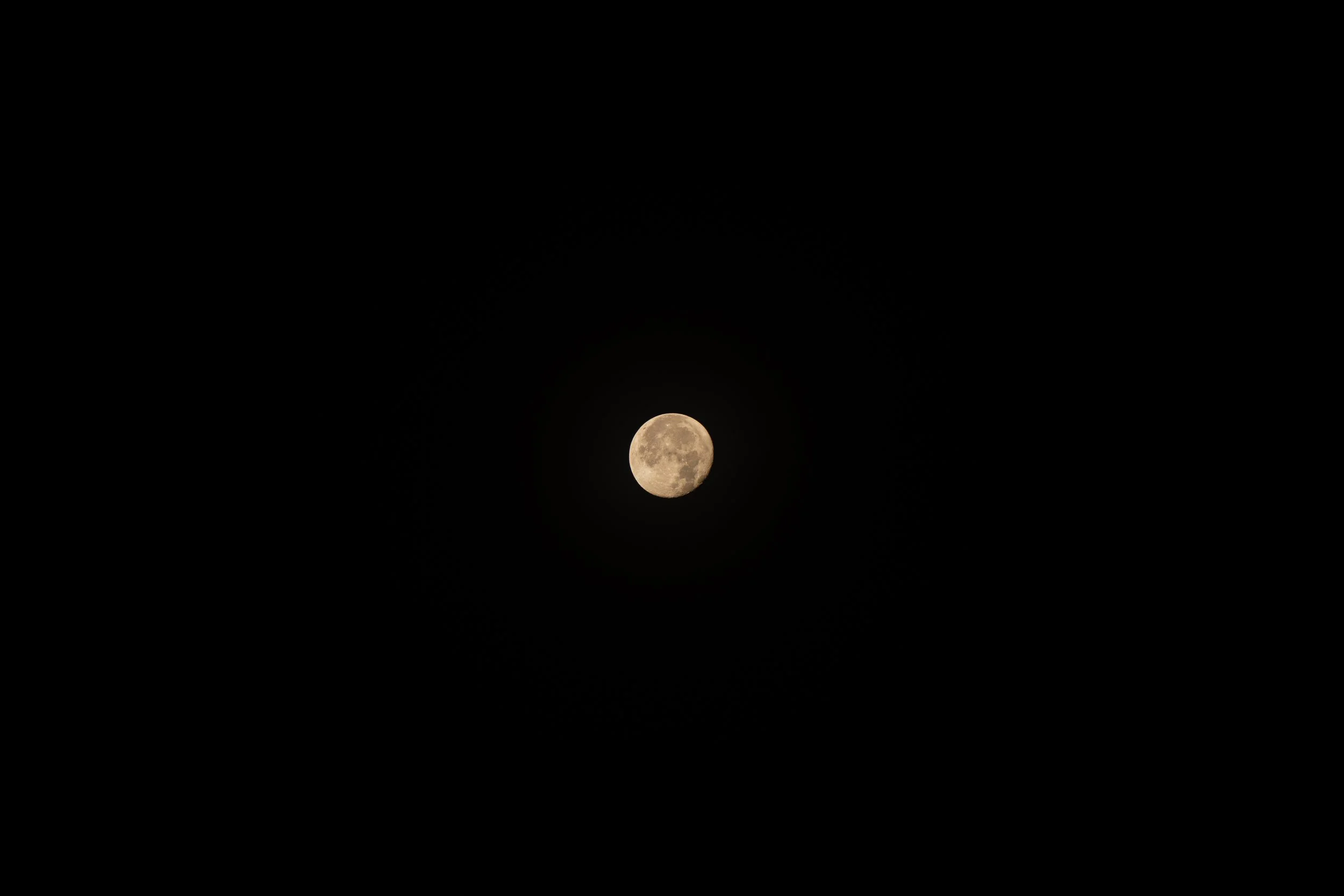 A bright full moon against a black night sky.