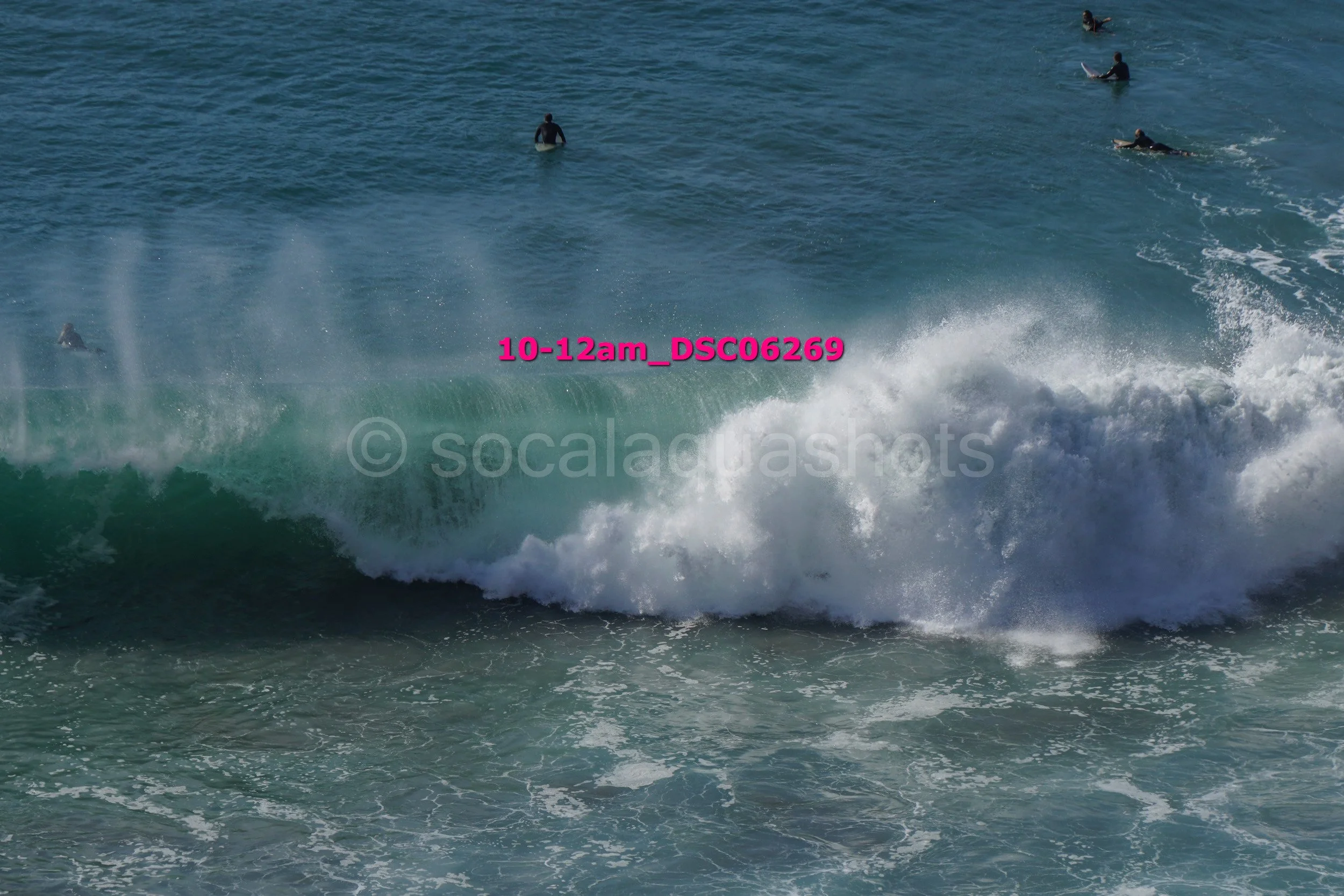 People surfing on ocean waves near the shoreline.