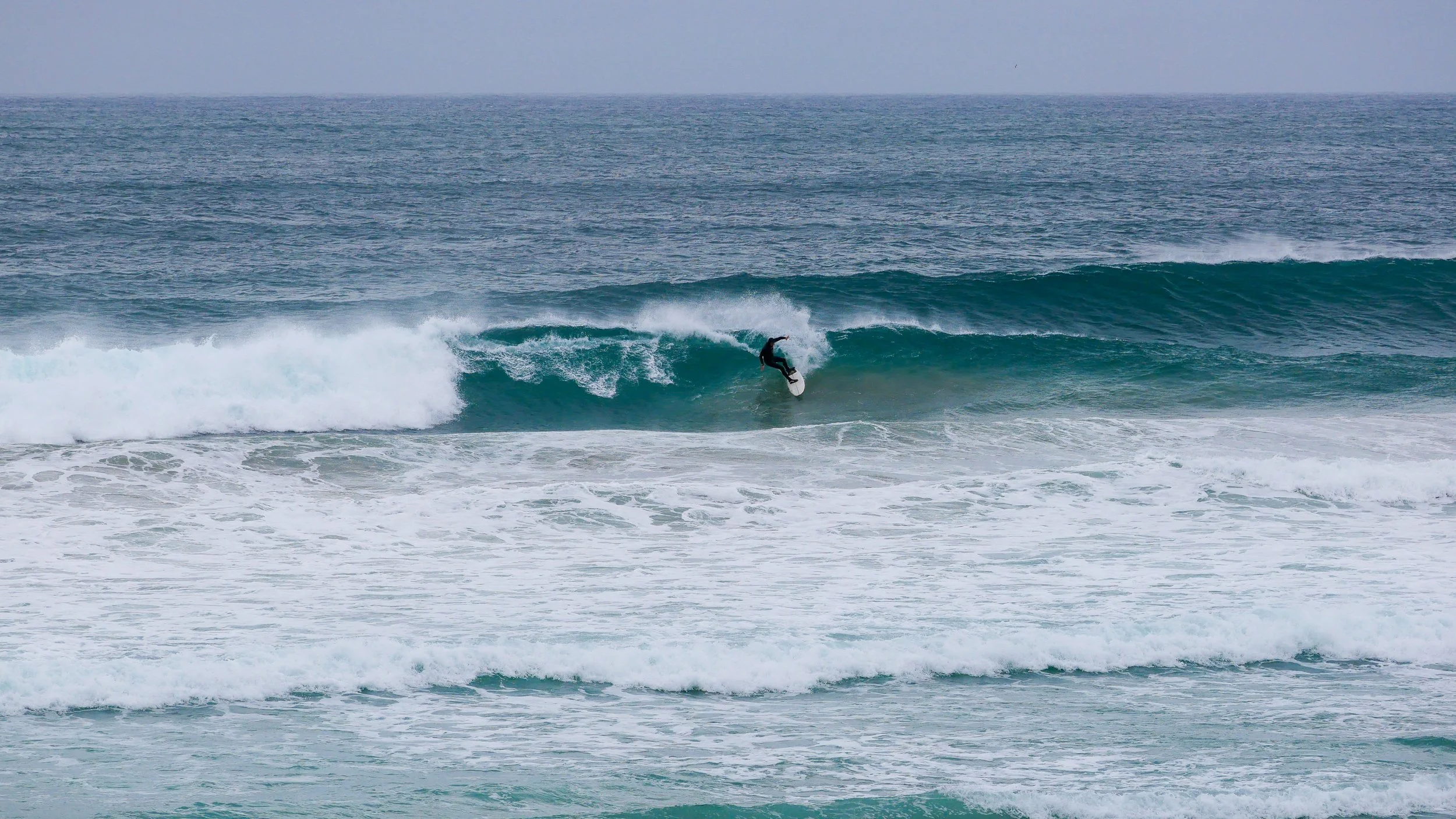 Surfer riding a wave in the ocean