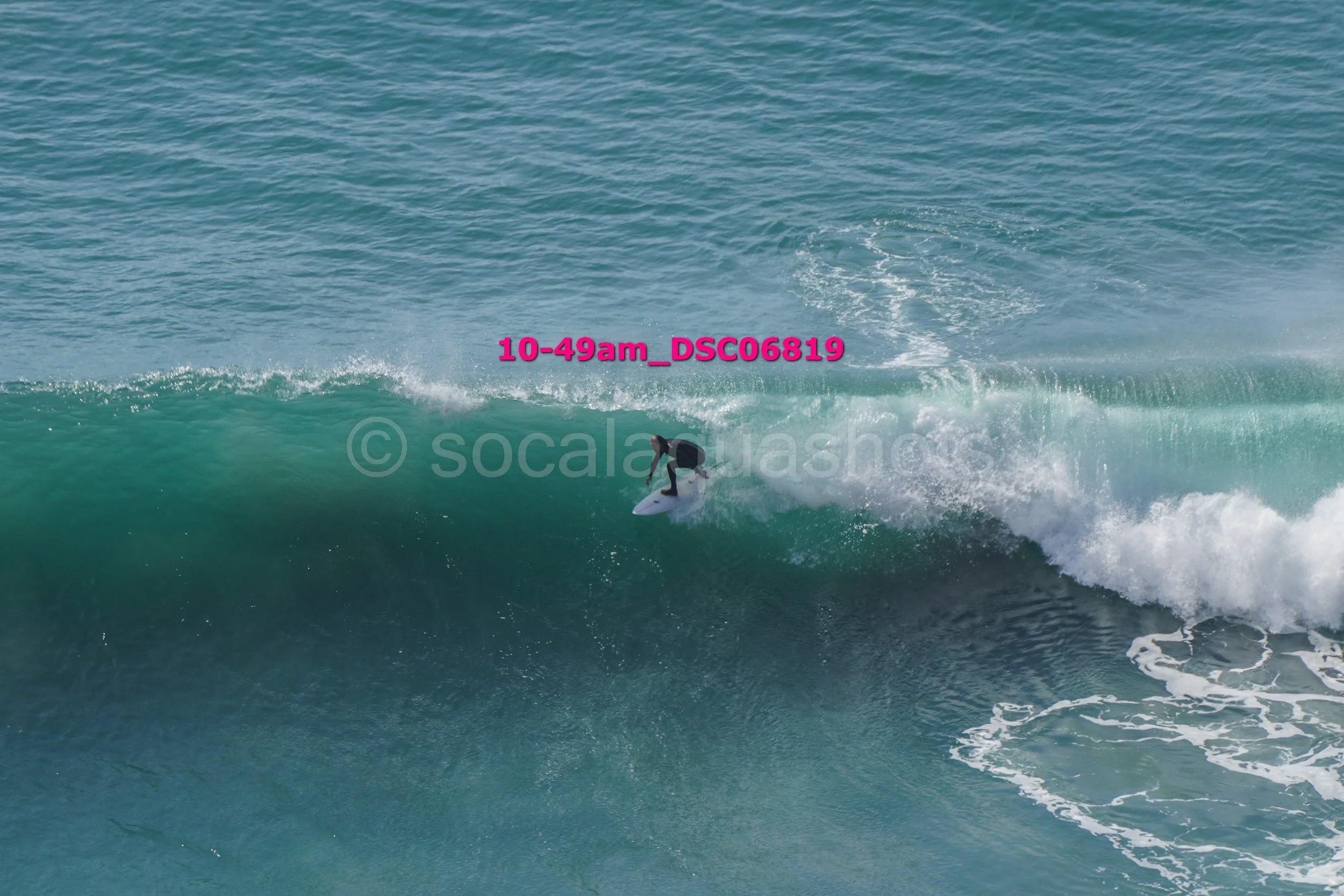 A person surfing on a wave in the ocean.