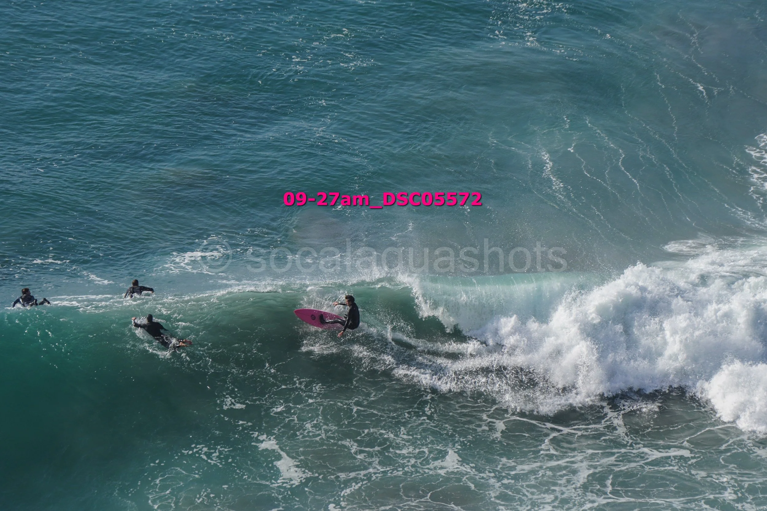 Surfers riding a wave in the ocean