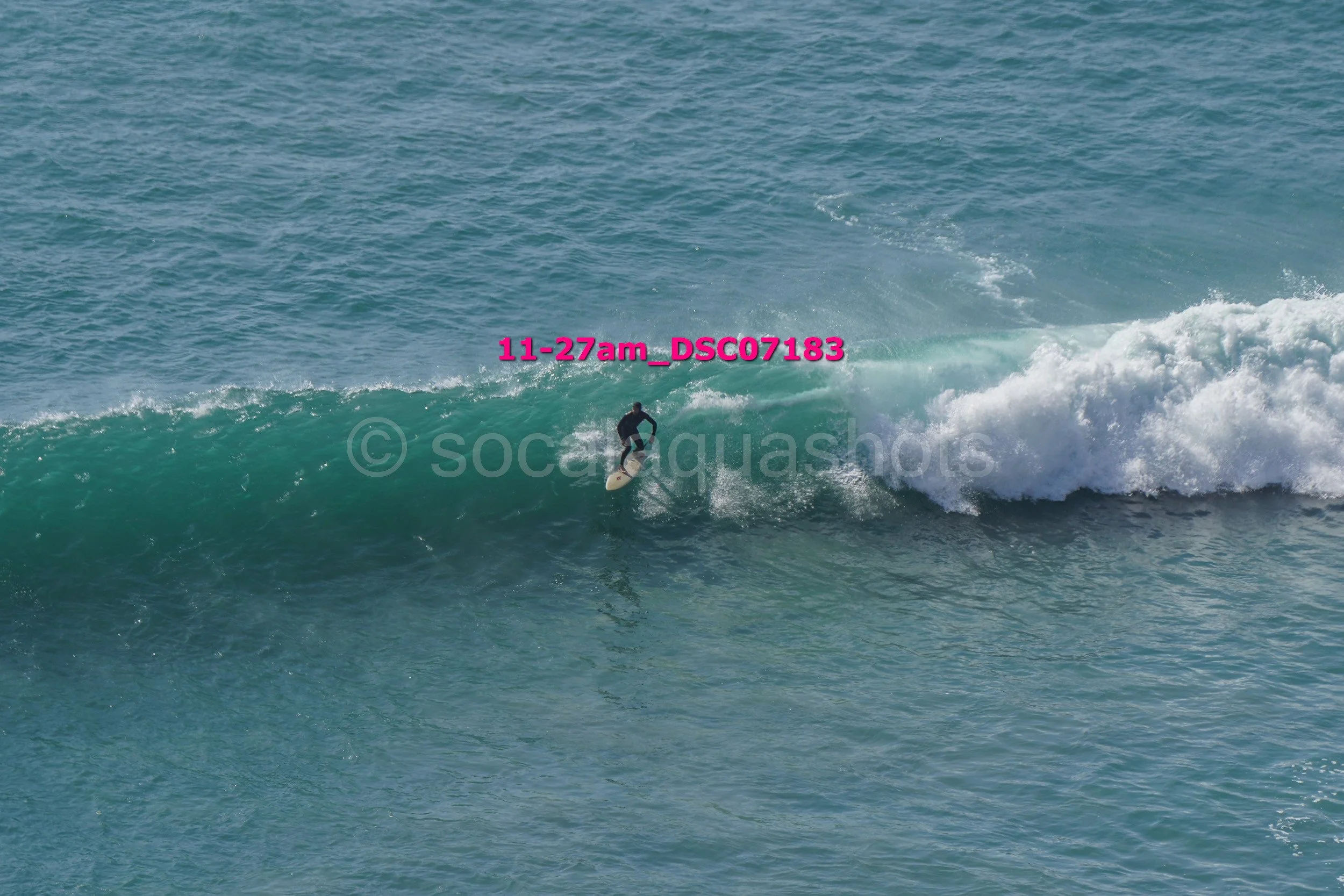 A person surfing on a wave in the ocean.