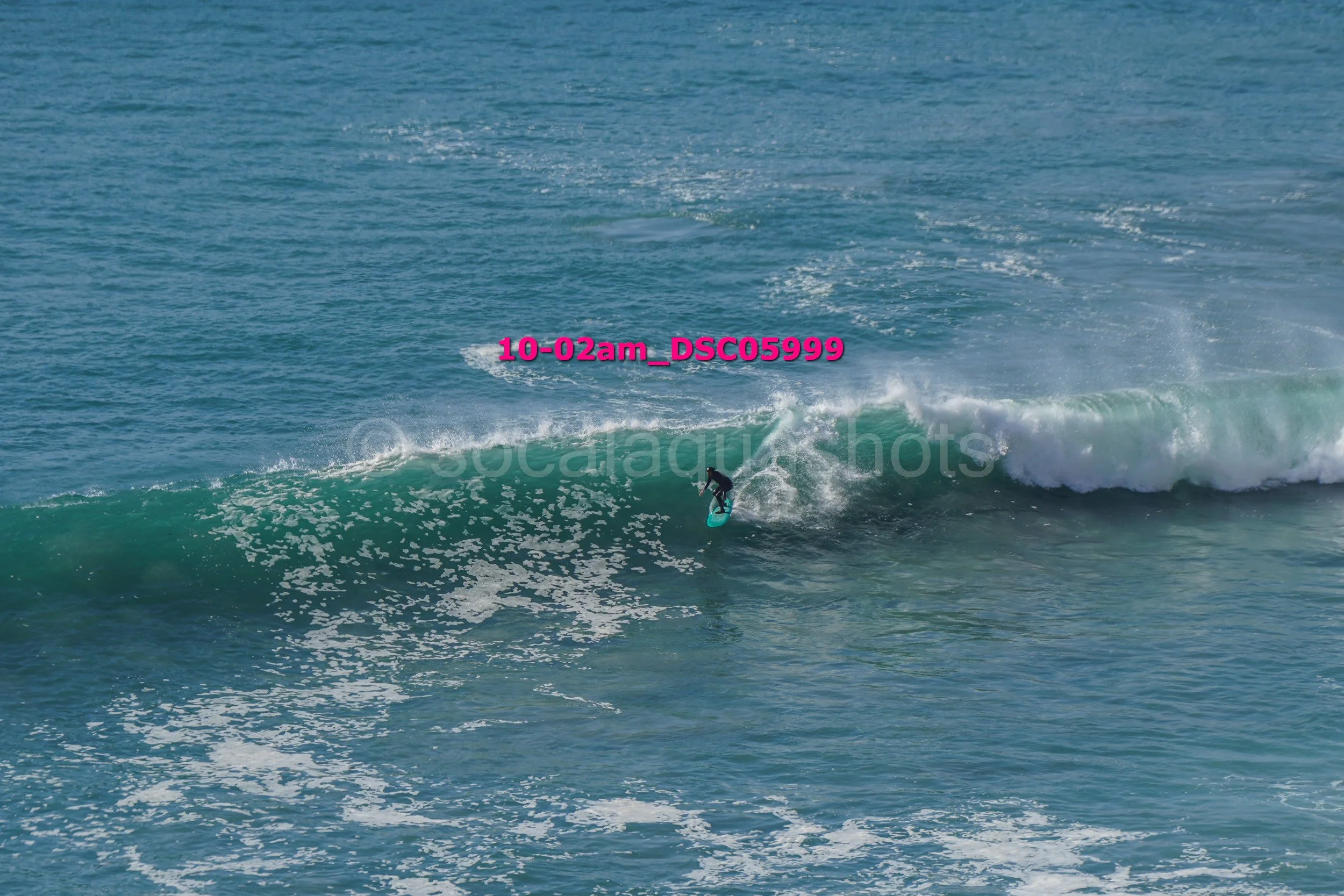 A person surfing on a wave in the ocean.