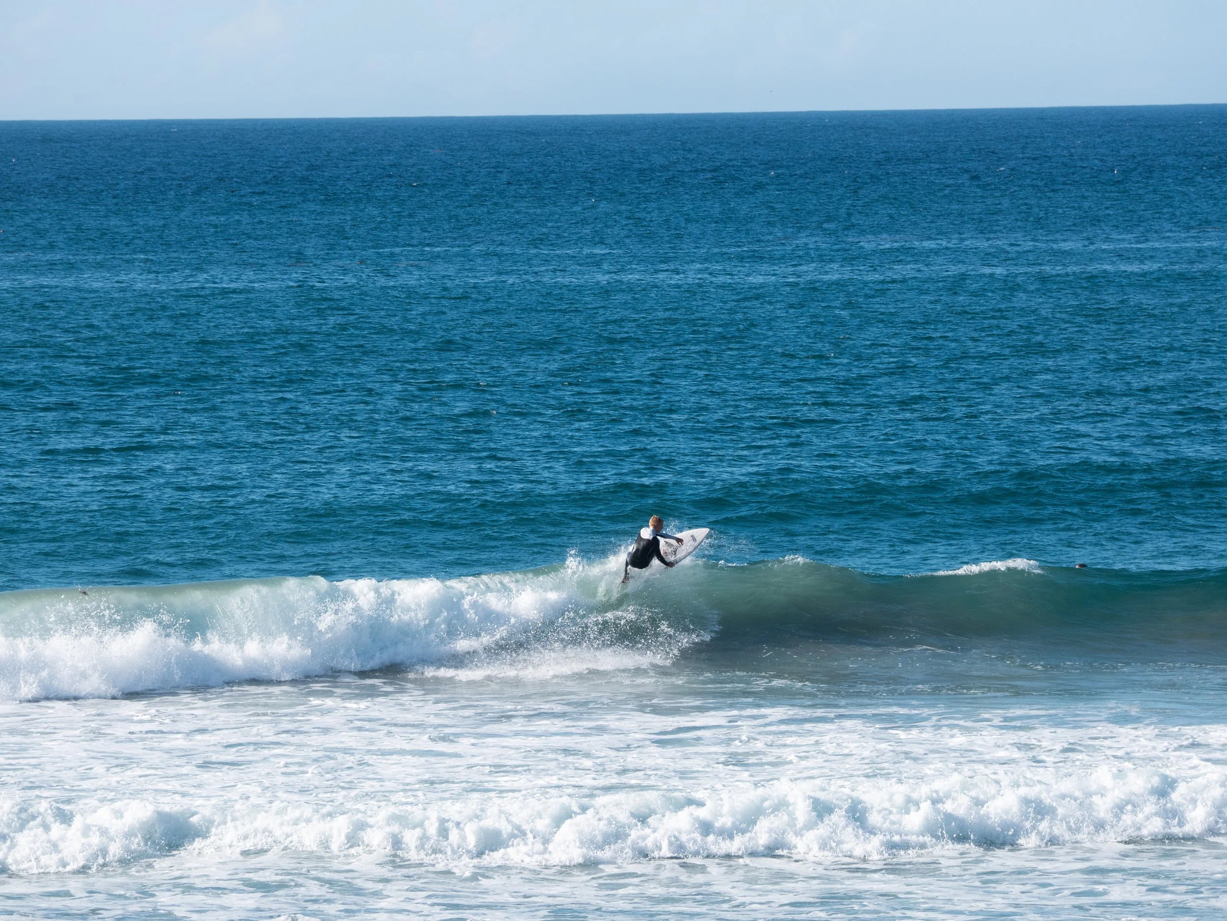 A person surfing on a wave in the ocean