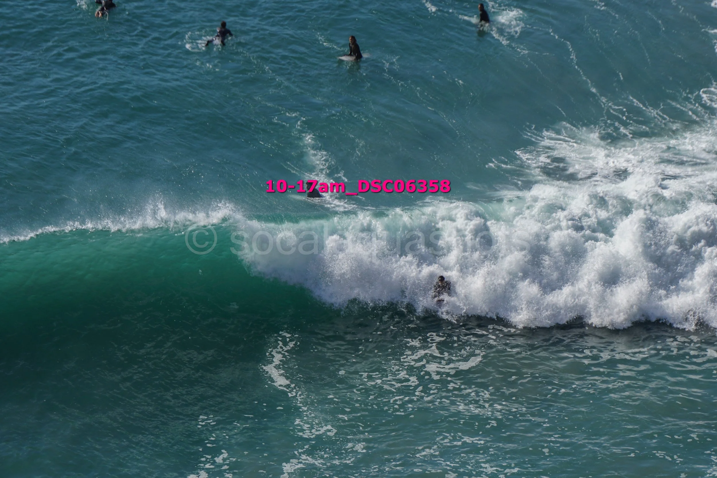 People surfing in the ocean with waves breaking.