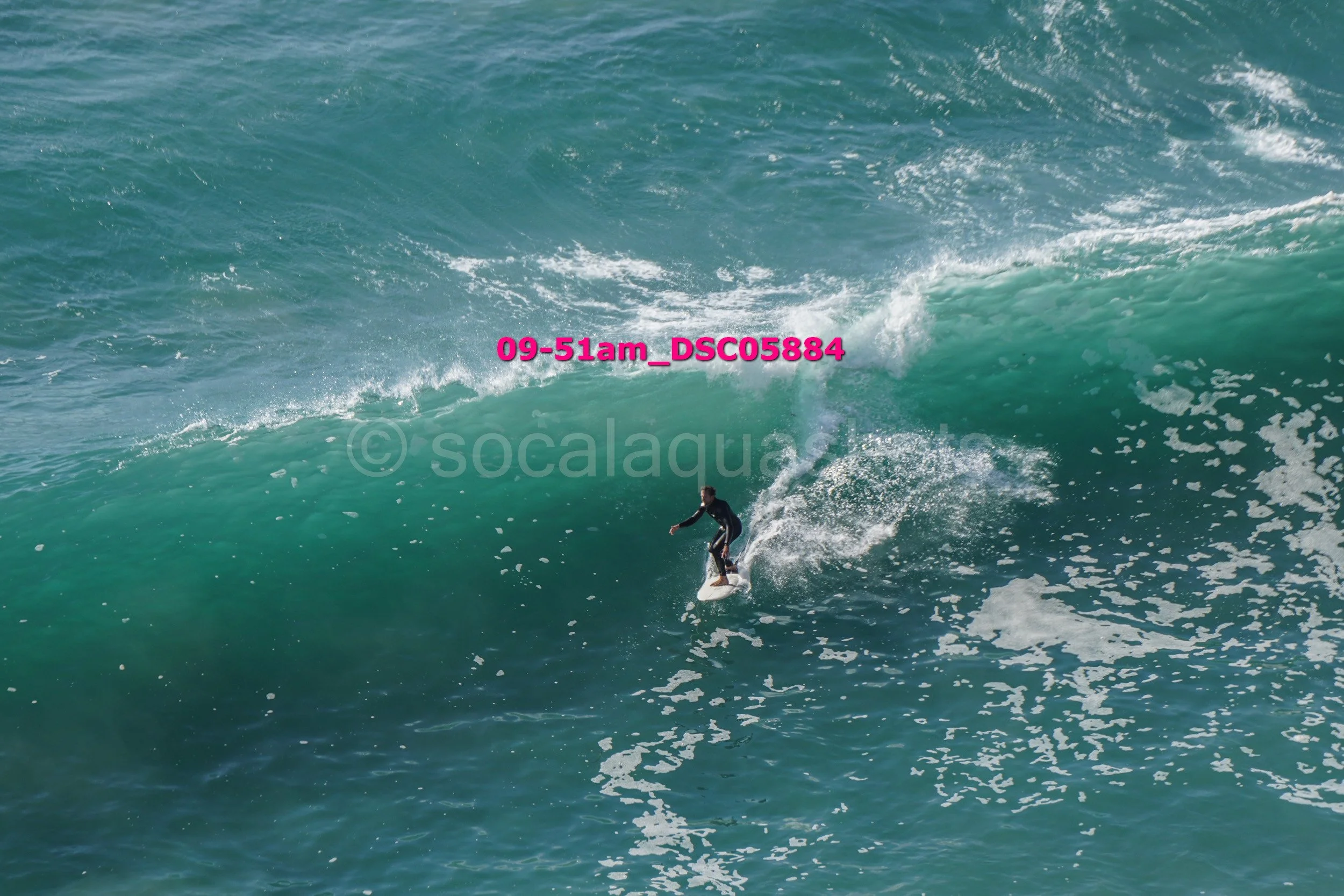 A person surfing on a large ocean wave.