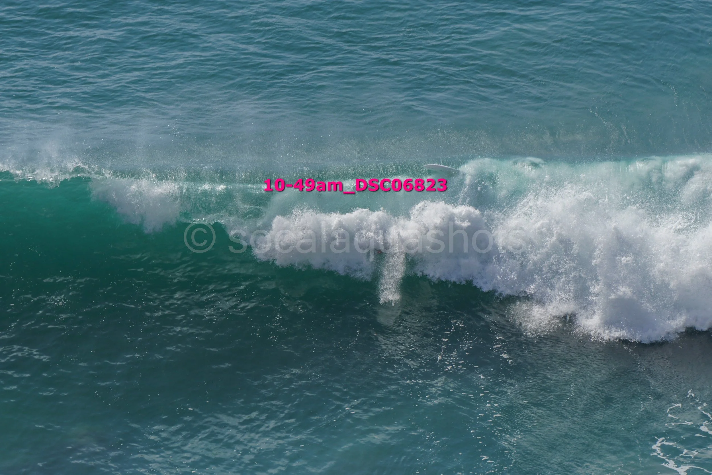 Ocean wave in the sea with white foam and blue water.