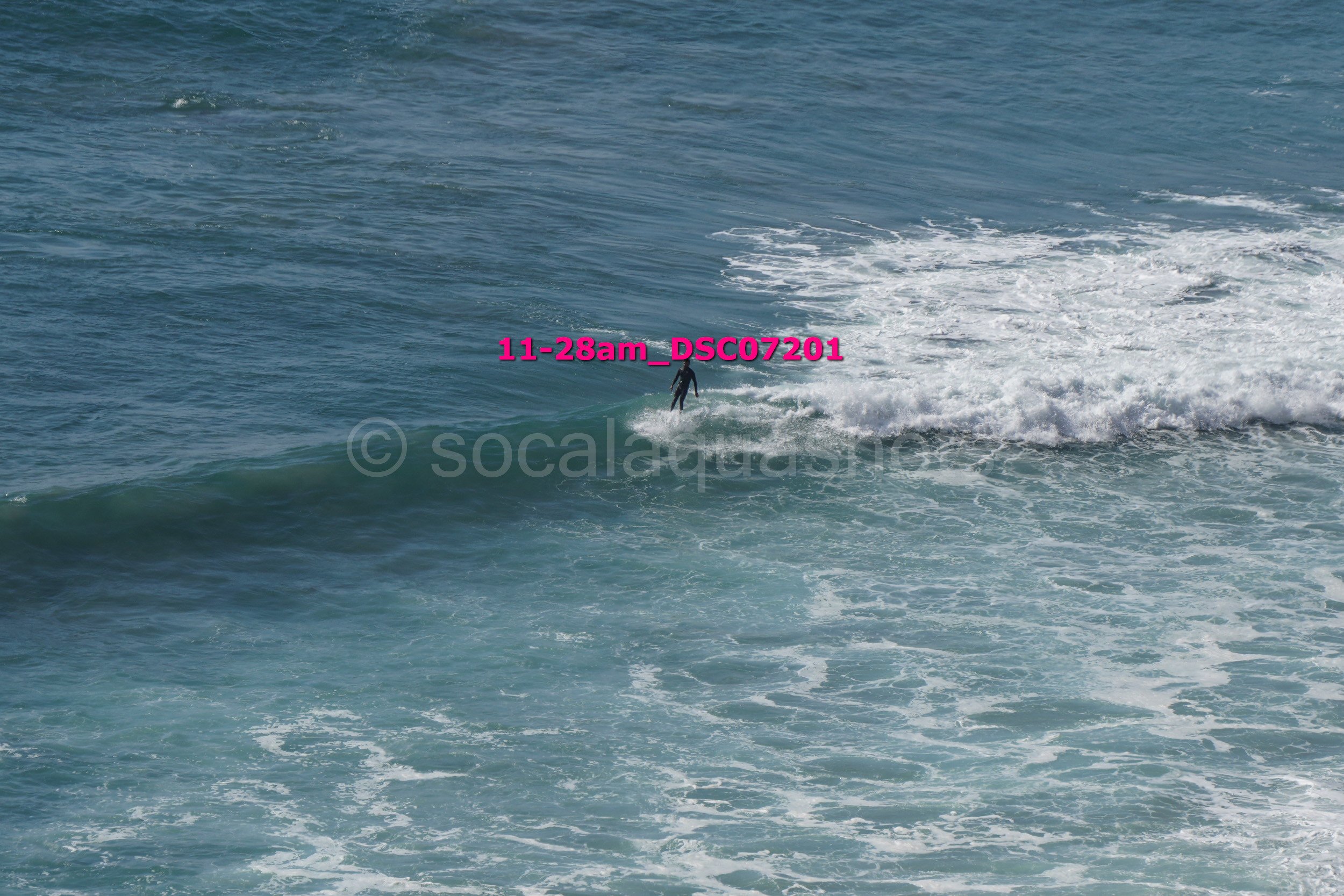 A person surfing on a wave in the ocean.