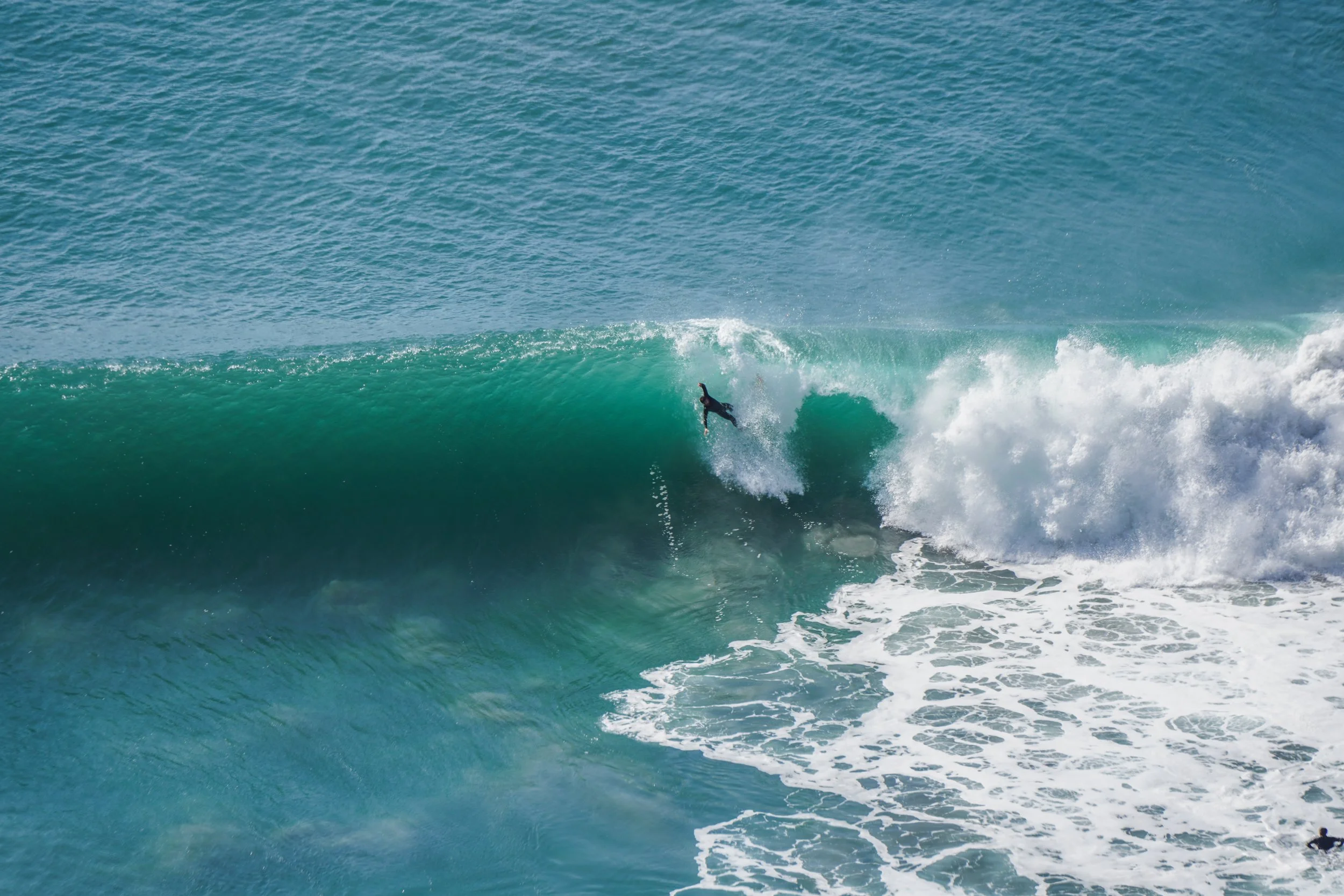 Surfer riding inside a large ocean wave