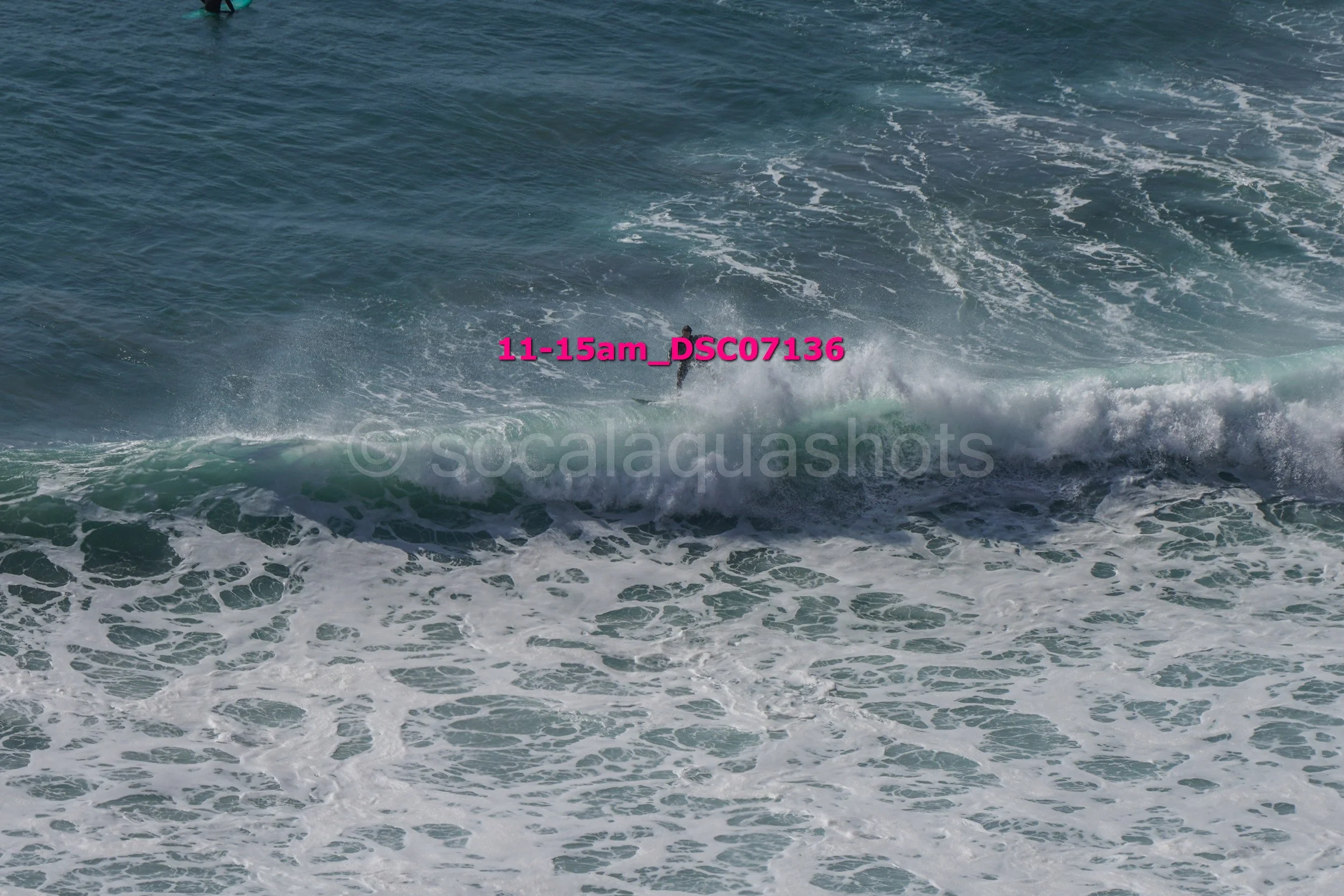 A person surfing on a wave in the ocean