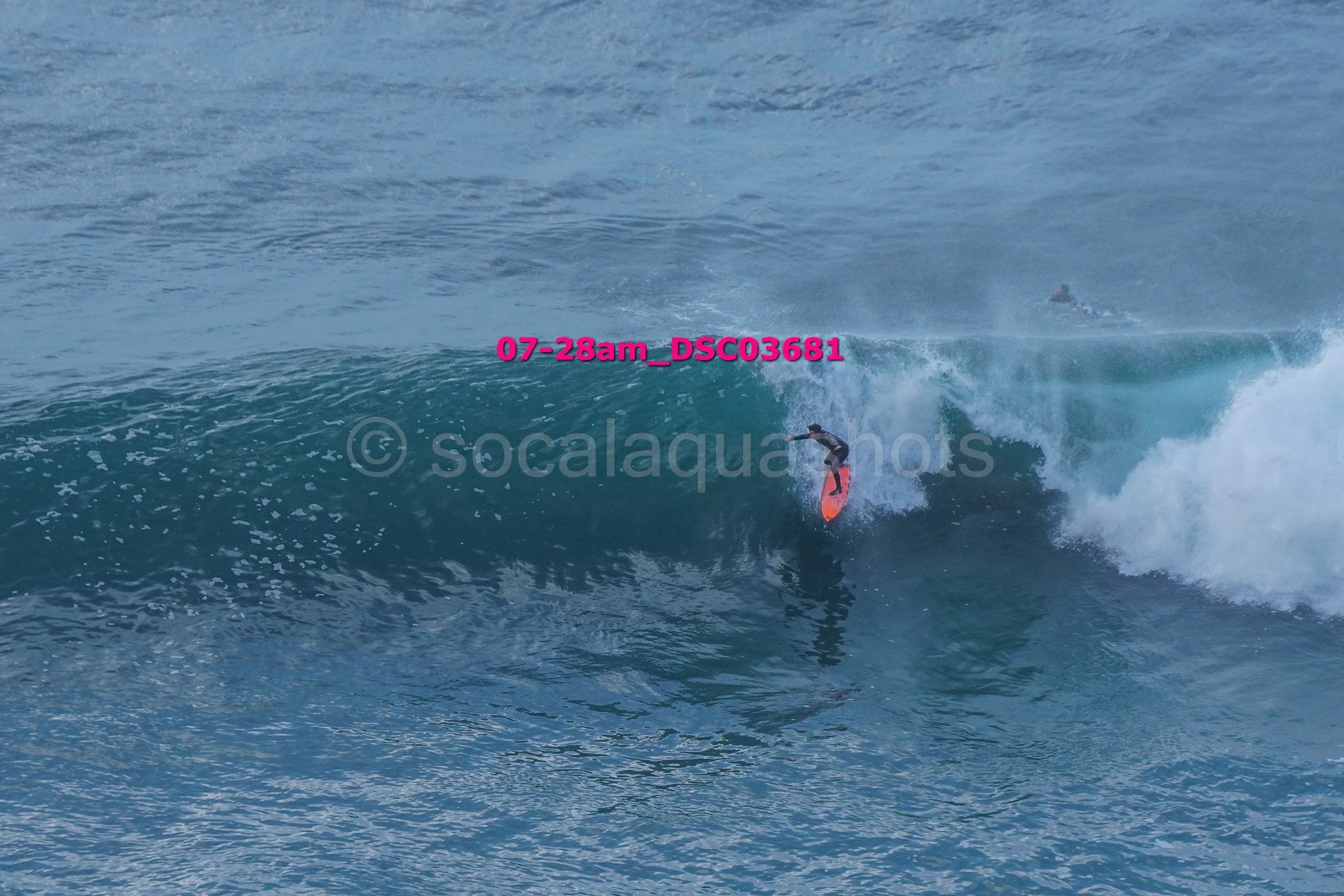 A person surfing on a wave in the ocean.