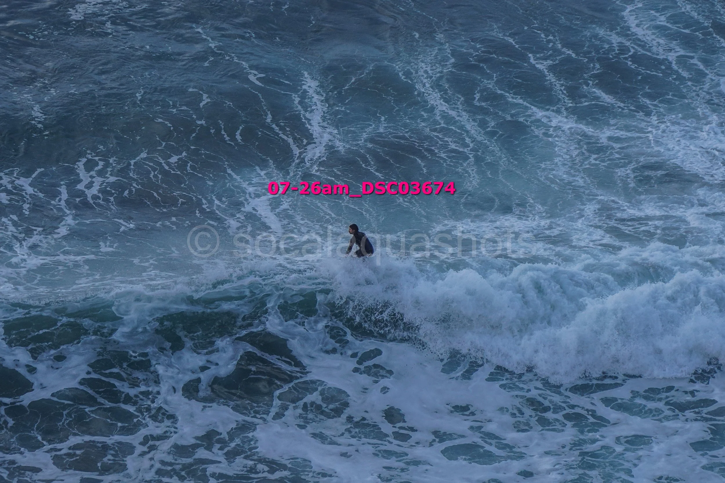A person surfing on a wave in the ocean