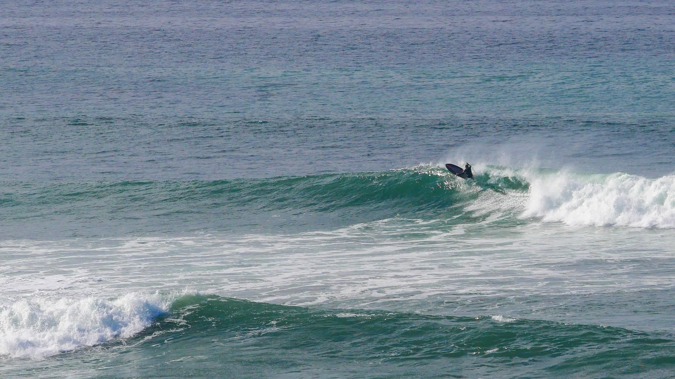 Surfer riding a wave in the ocean