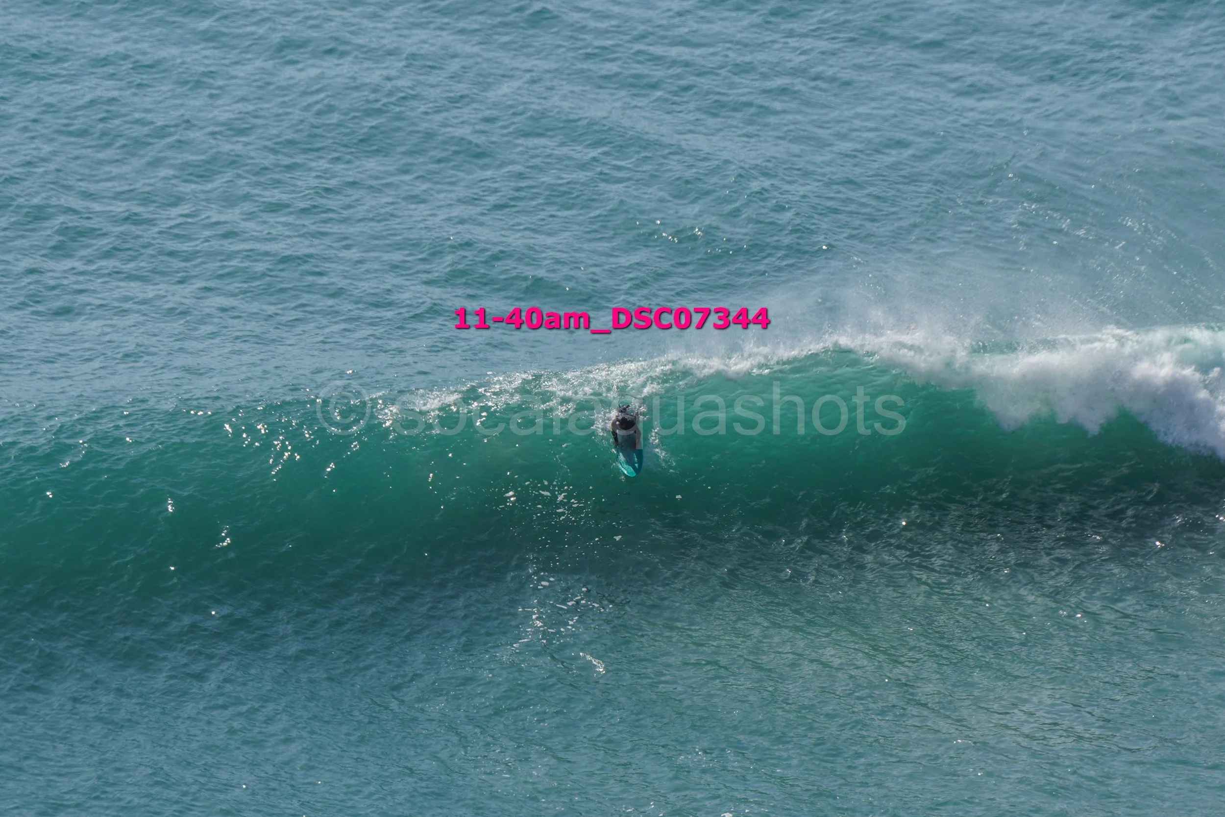 A surfer riding a large wave in the ocean.