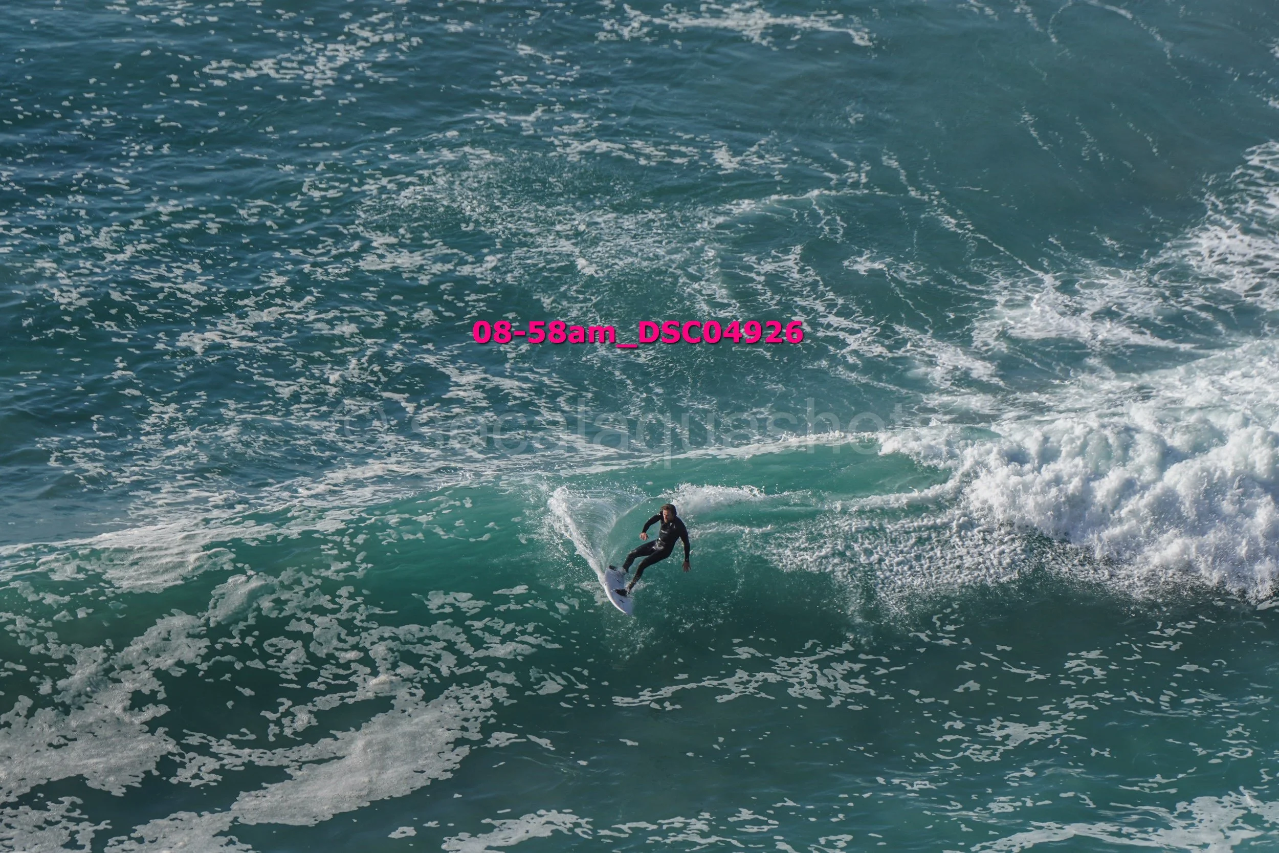 A person surfing on a wave in the ocean during daytime.