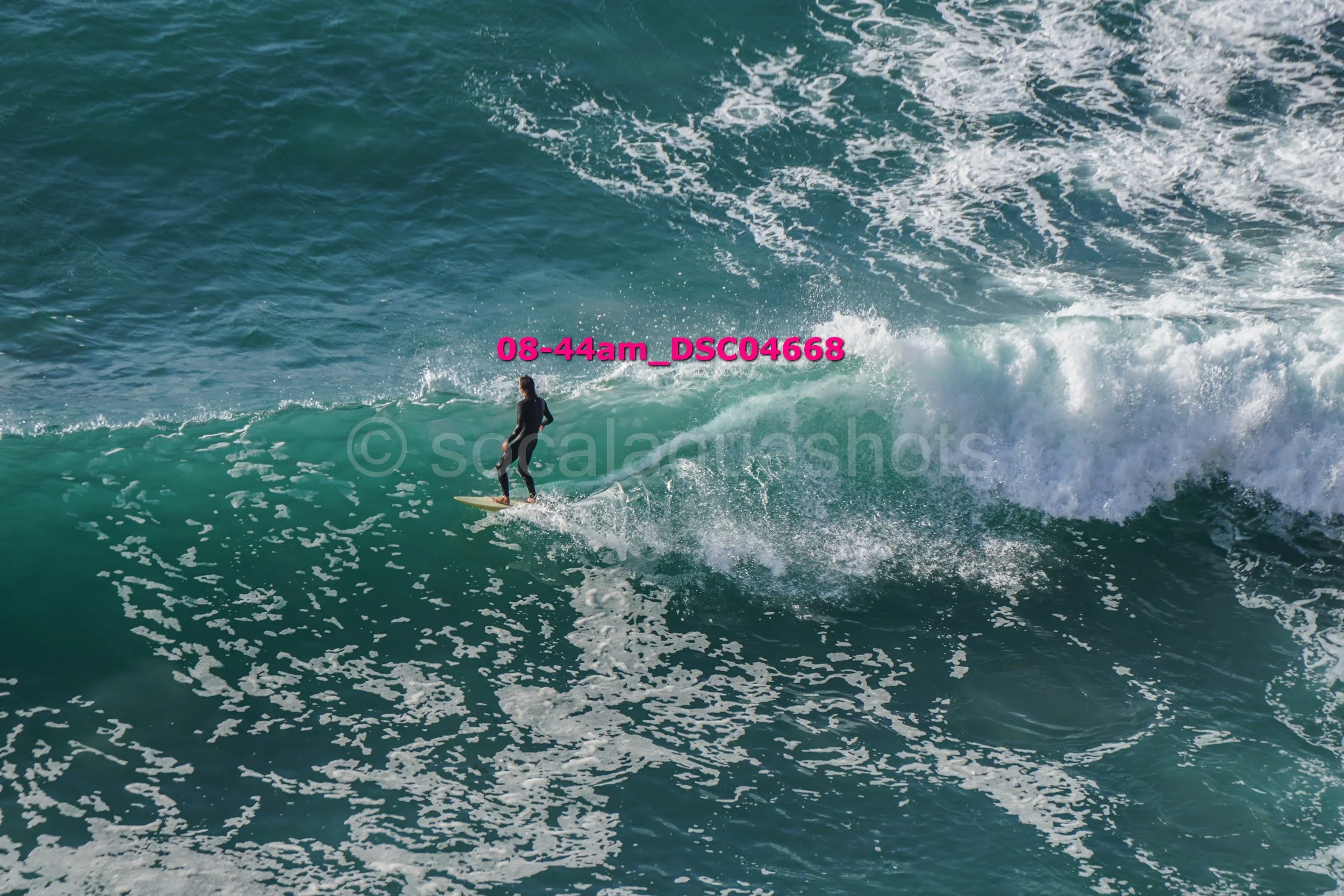 A person surfing on a wave in the ocean.