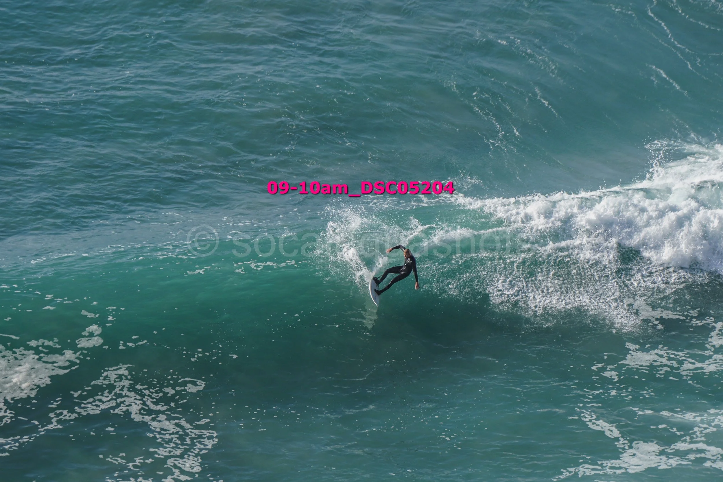 A person surfing on a wave in the ocean during daytime.