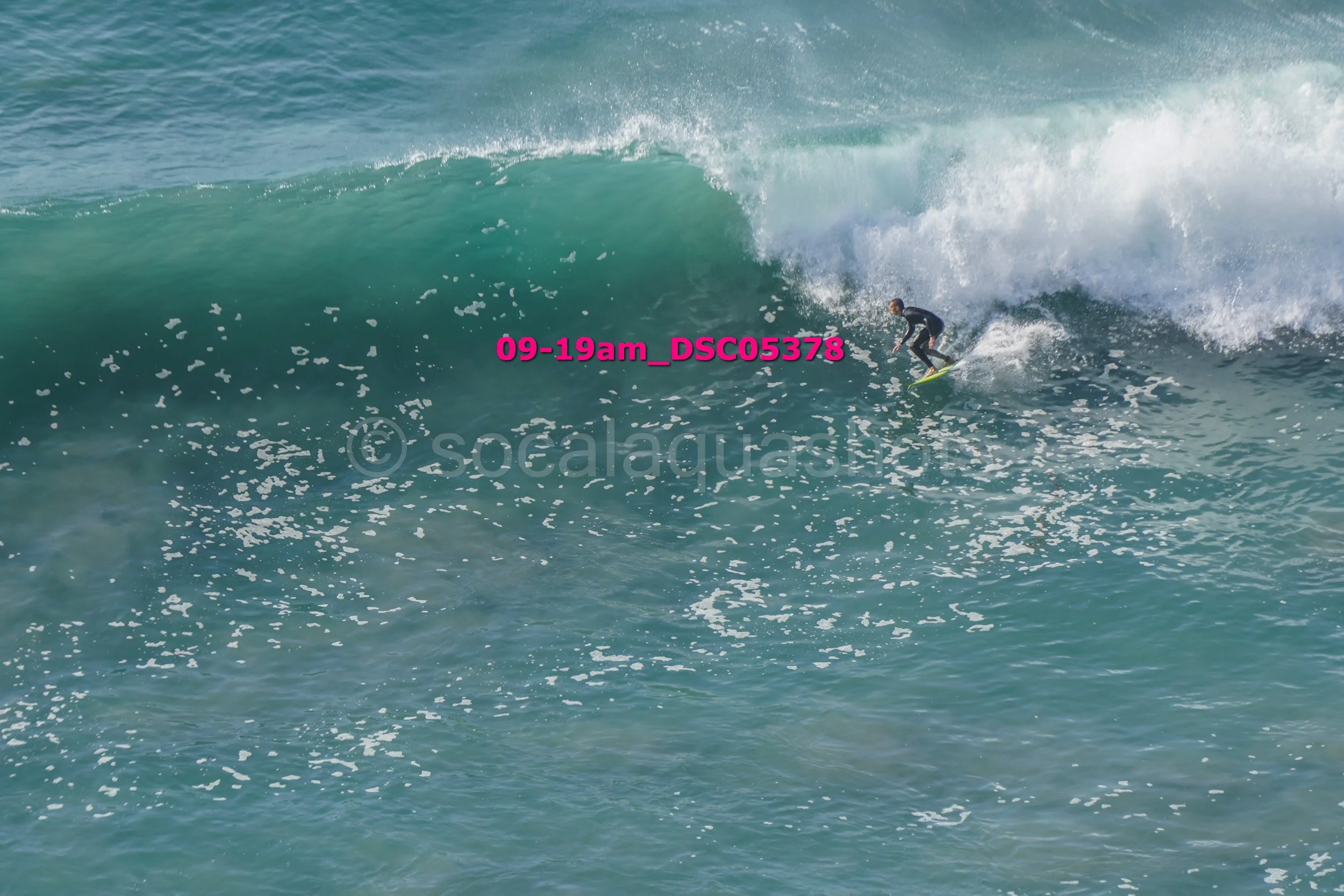 A person surfing on a large ocean wave.