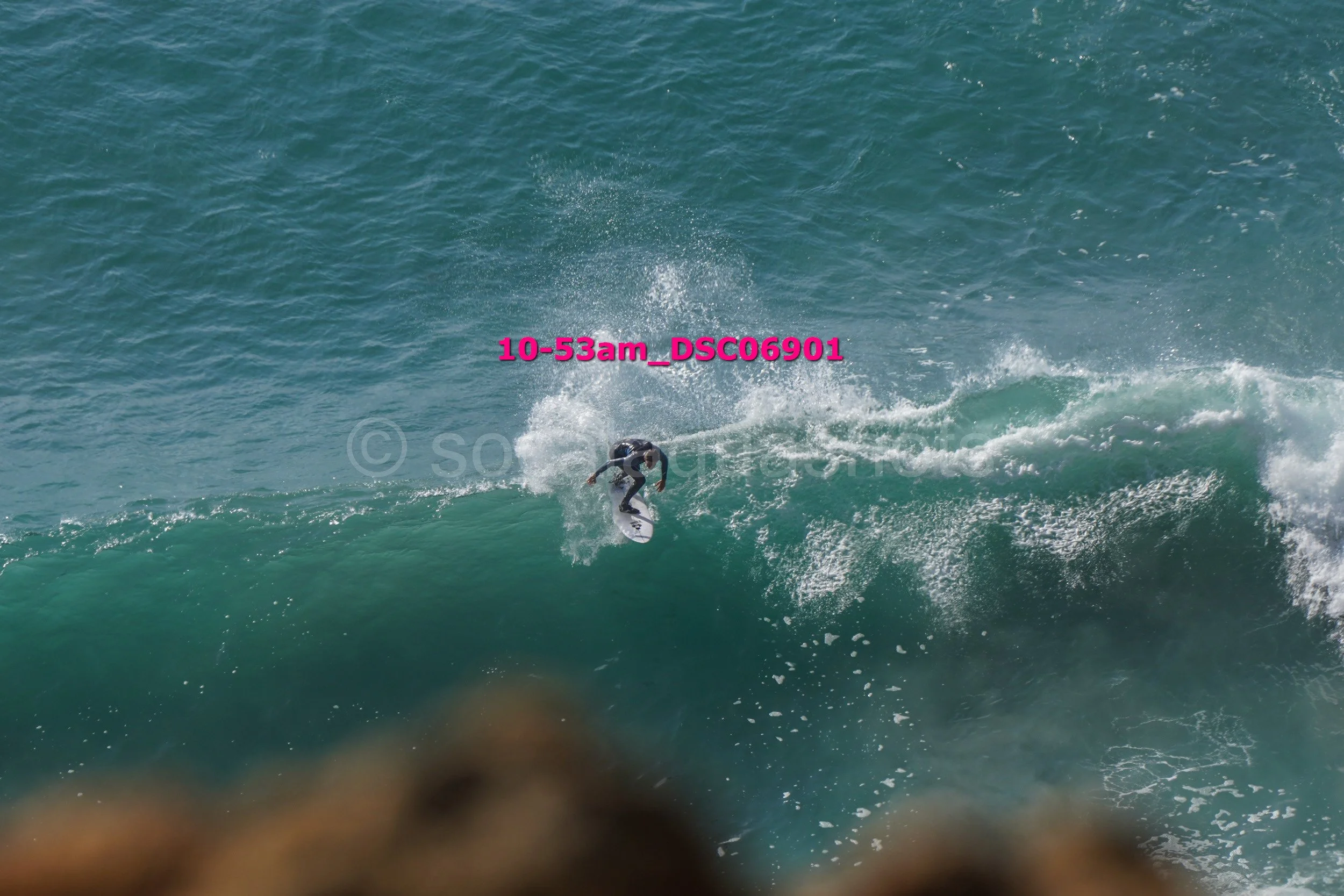 A person surfing on a wave in the ocean.