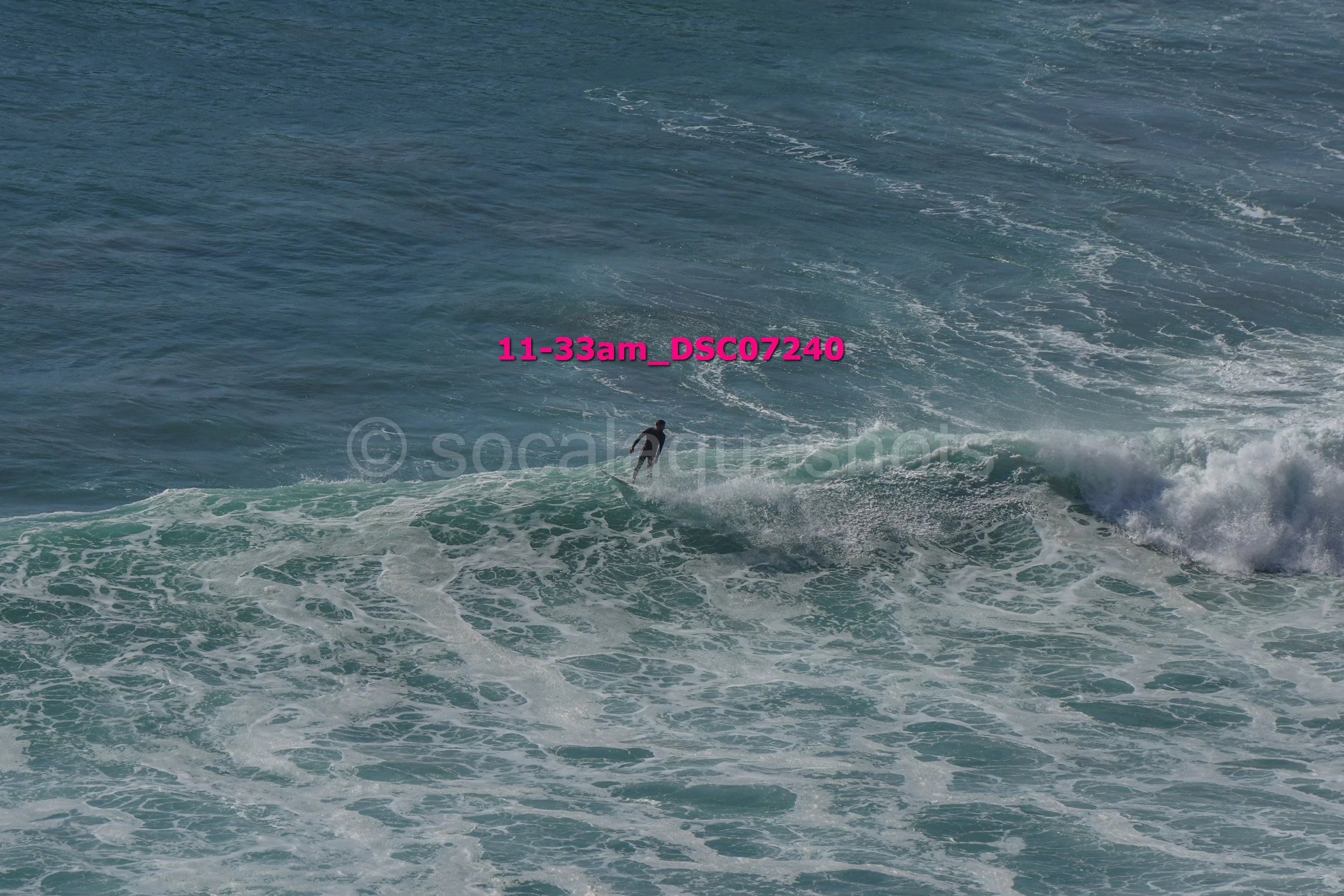 A person surfing on the ocean waves during daylight hours.