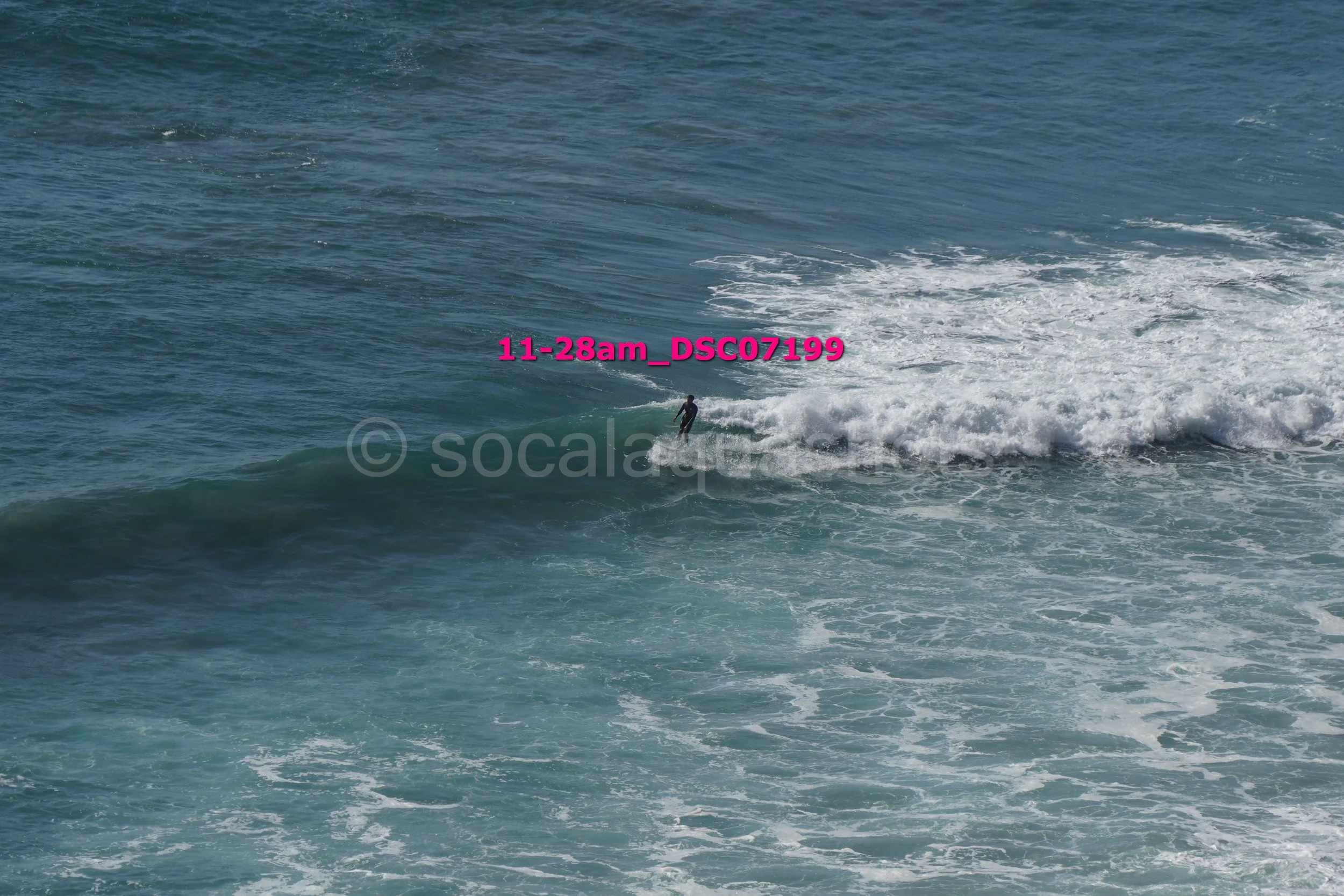 A person surfing on a wave in the ocean.