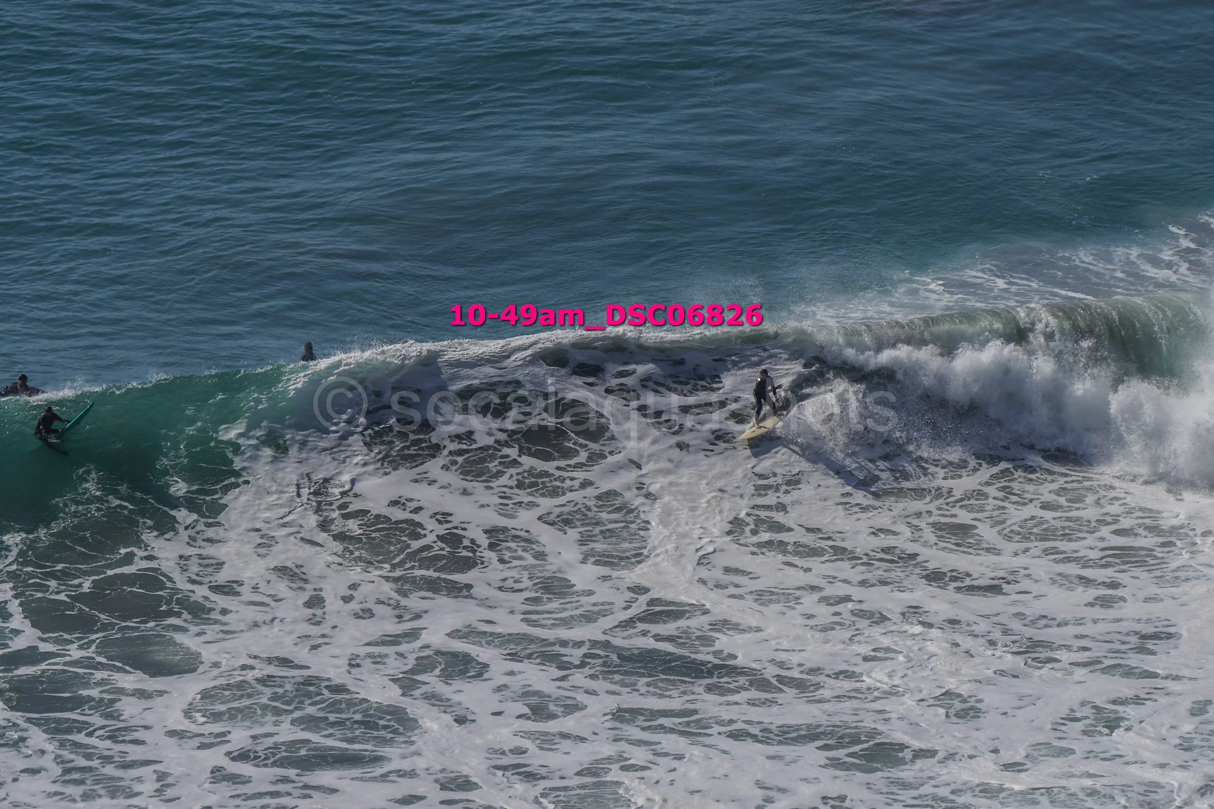 People surfing on large ocean waves.