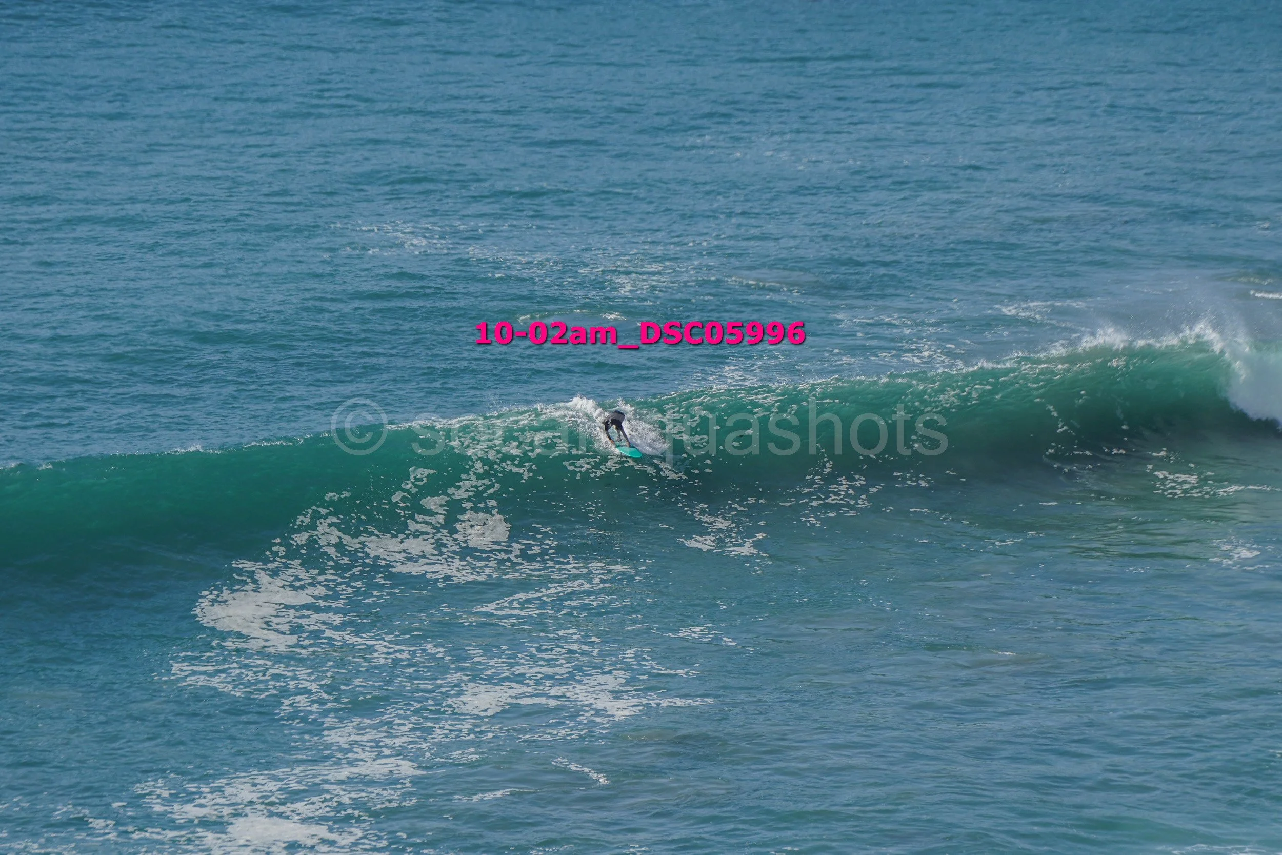 A person surfing on a wave in the ocean