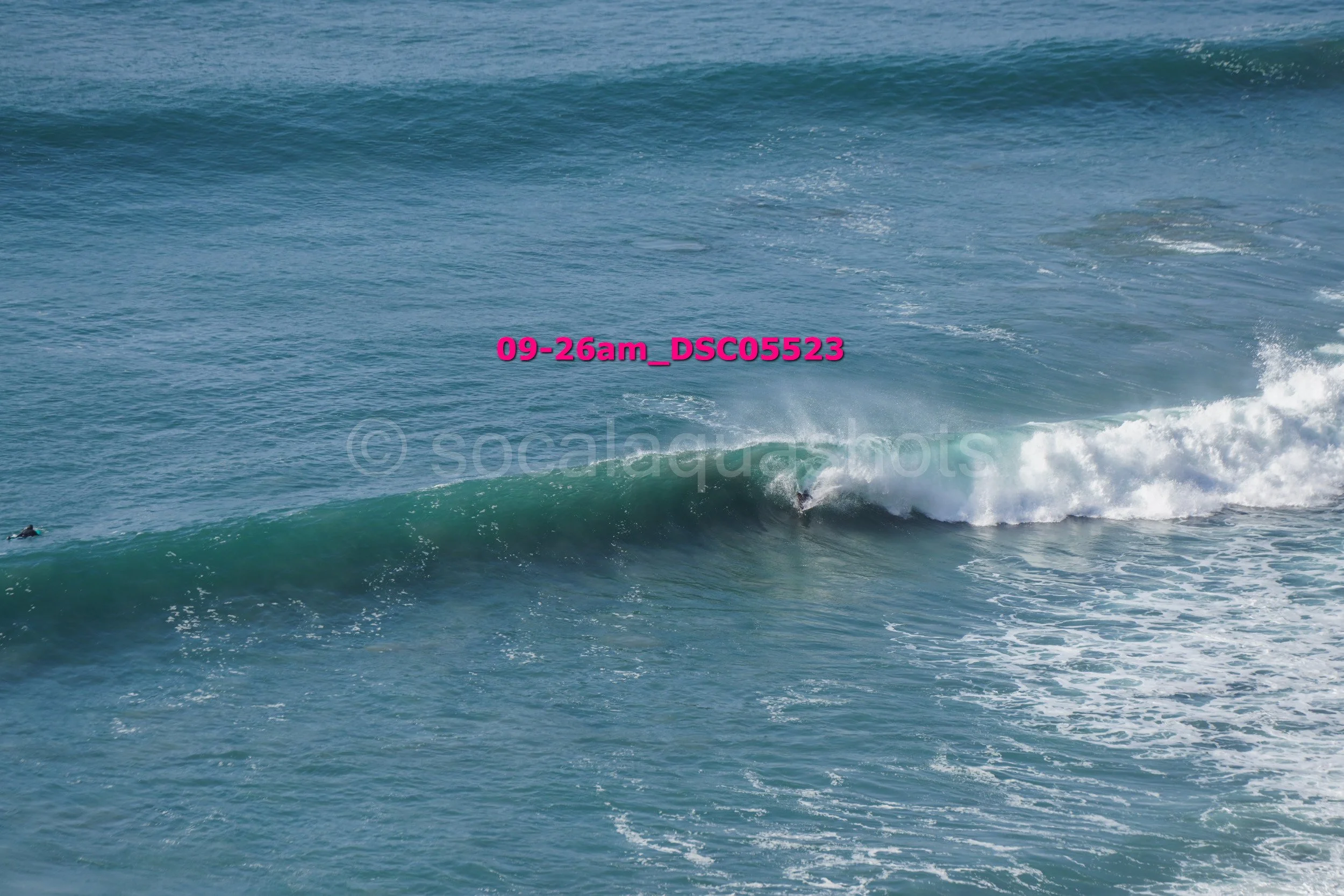 A surfer riding a wave in the ocean.