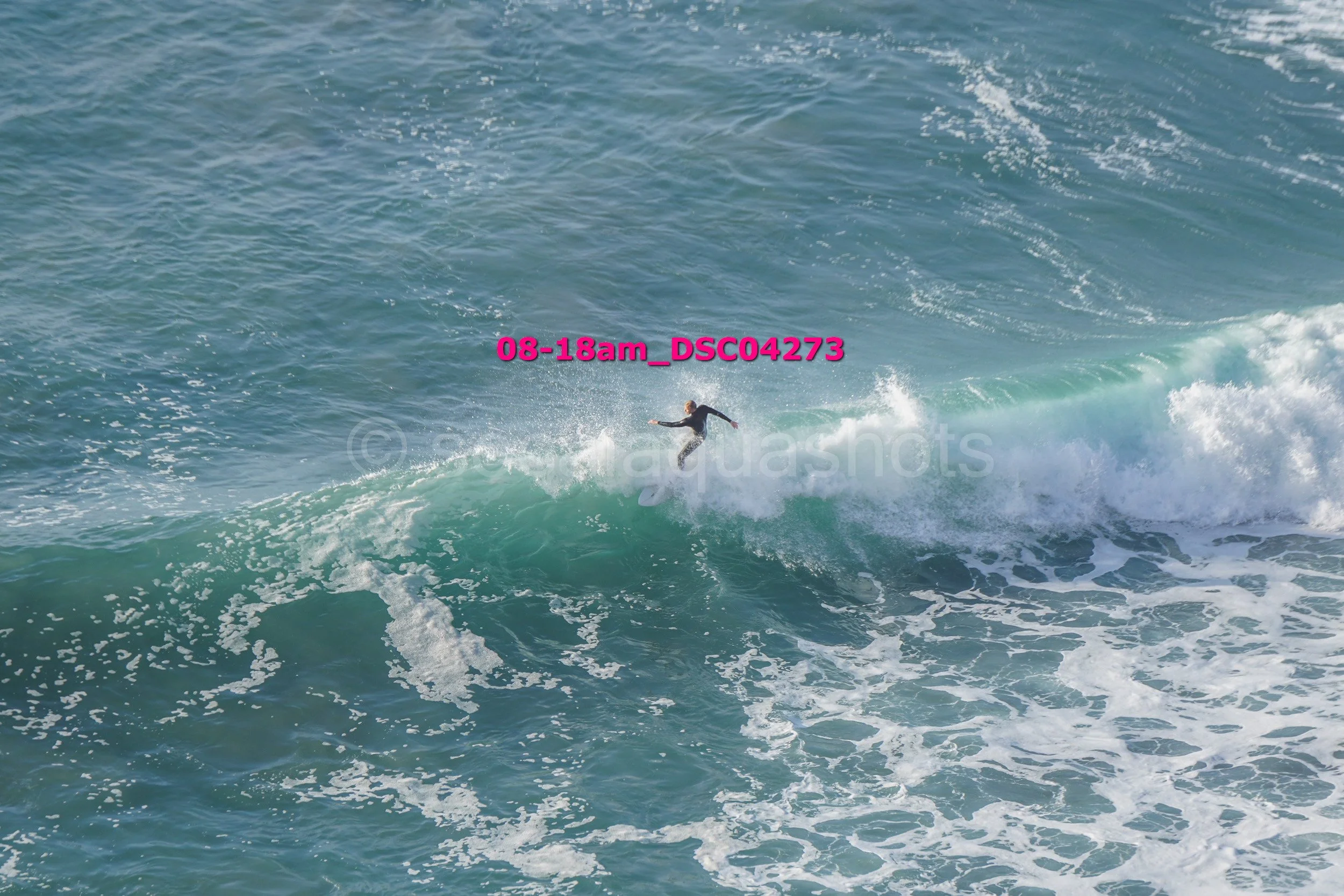 A person surfing on a wave in the ocean.