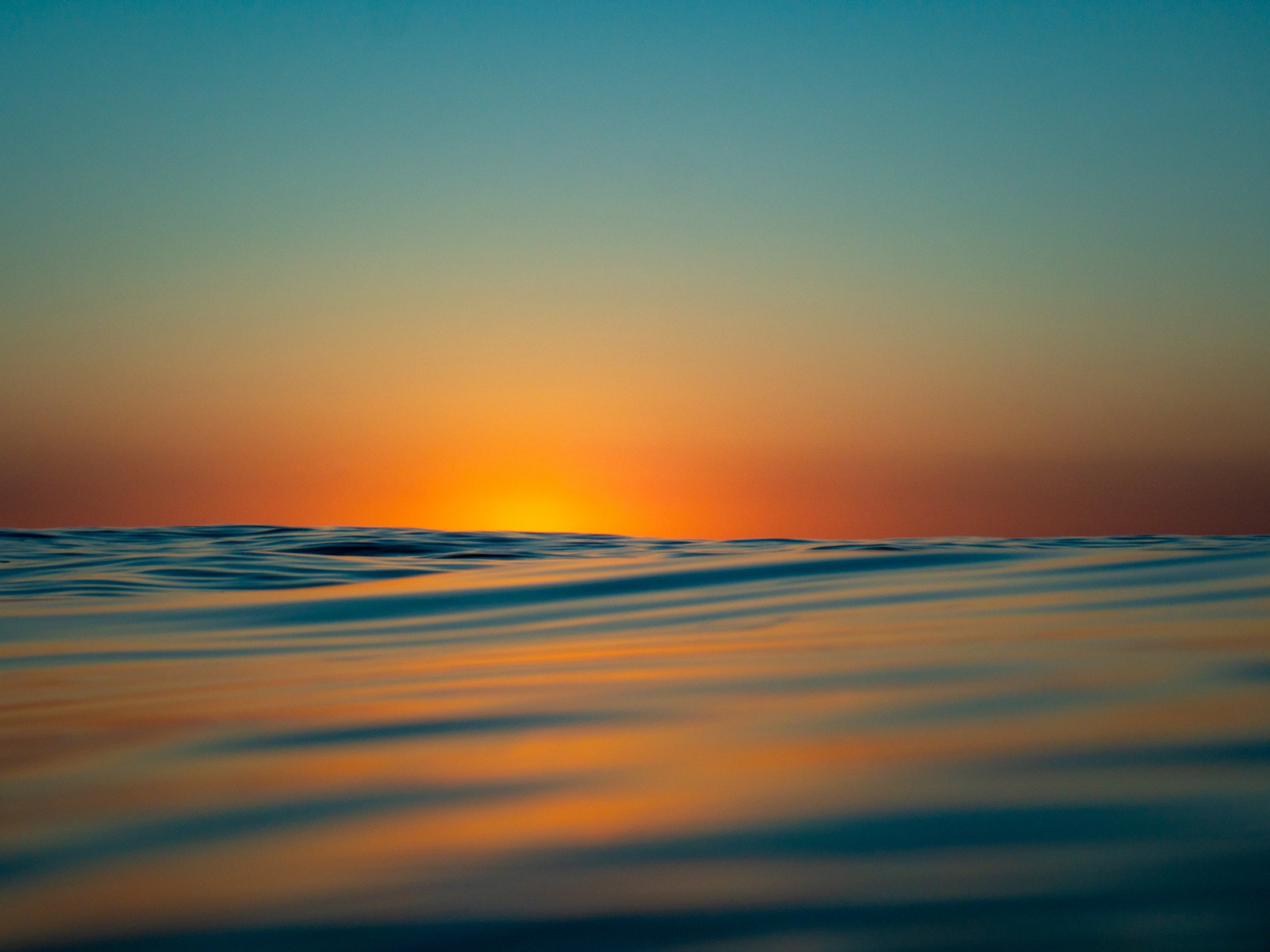 Ocean sunset with golden sky and gentle waves