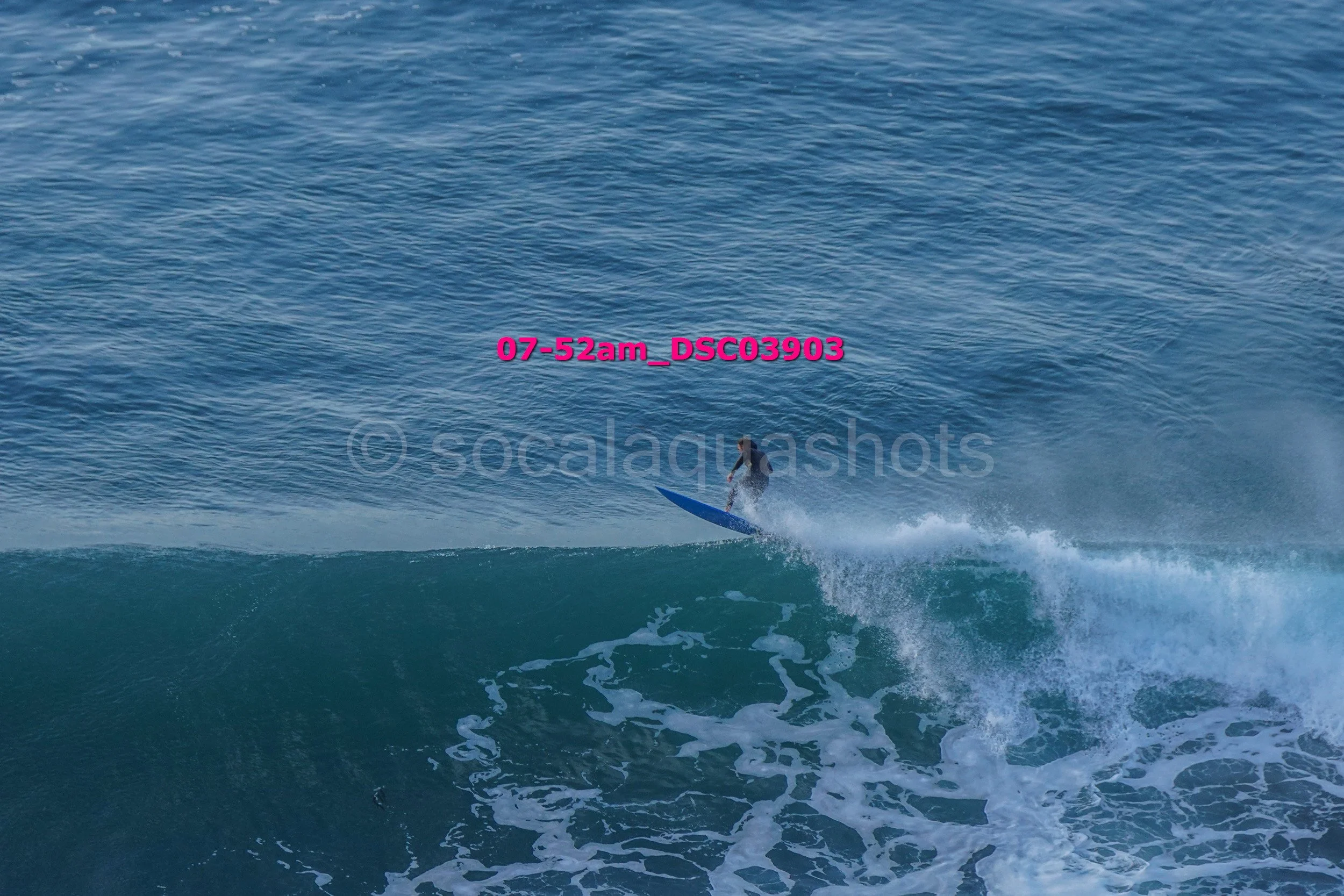 Surfer riding a large wave in the ocean during the daytime.